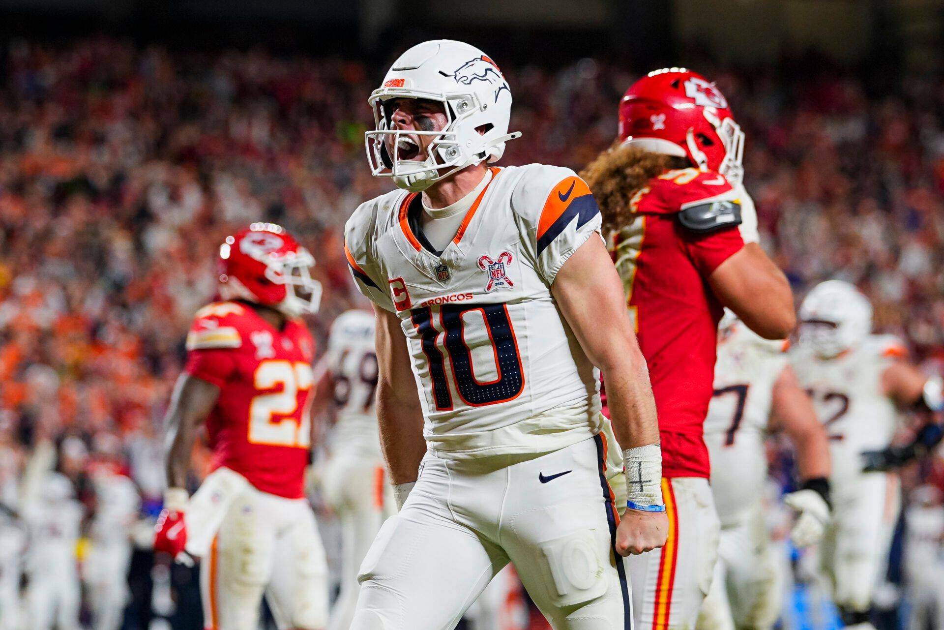 Denver Broncos quarterback Bo Nix (10) celebrates after scoring a touchdown during the second half against the Kansas City Chiefs at GEHA Field at Arrowhead Stadium.