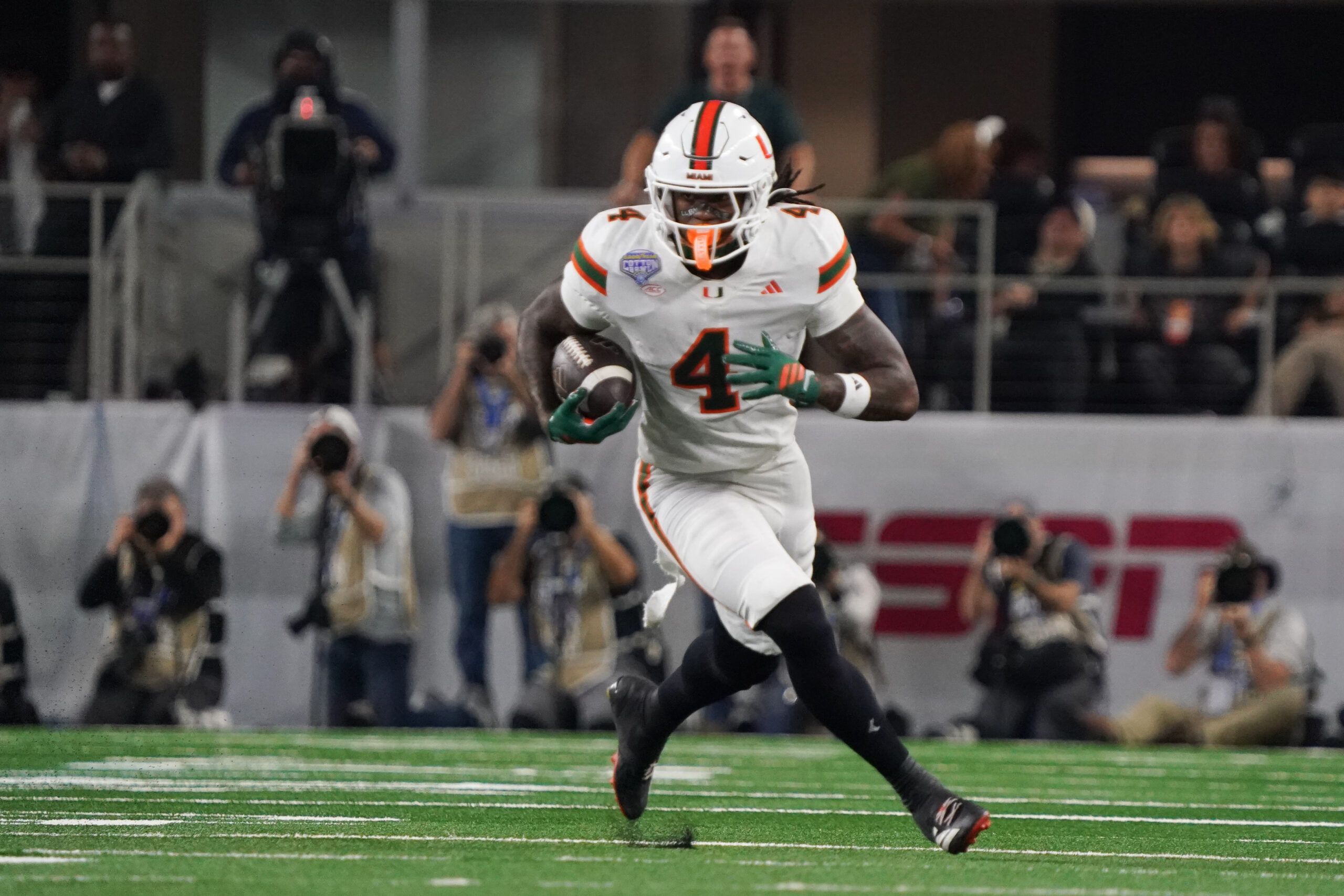 Miami Hurricanes defensive lineman Rueben Bain Jr. (4) moves the ball in the first quarter against the Ohio State Buckeyes during the 2025 Cotton Bowl and quarterfinal game of the College Football Playoff at AT&T Stadium.