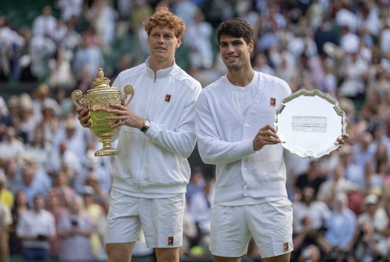 Carlos Alcaraz of Spain and Jannik Sinner of Italy pose with their trophies after the menÕs singles final on day 14 at All England Lawn Tennis and Croquet Club.