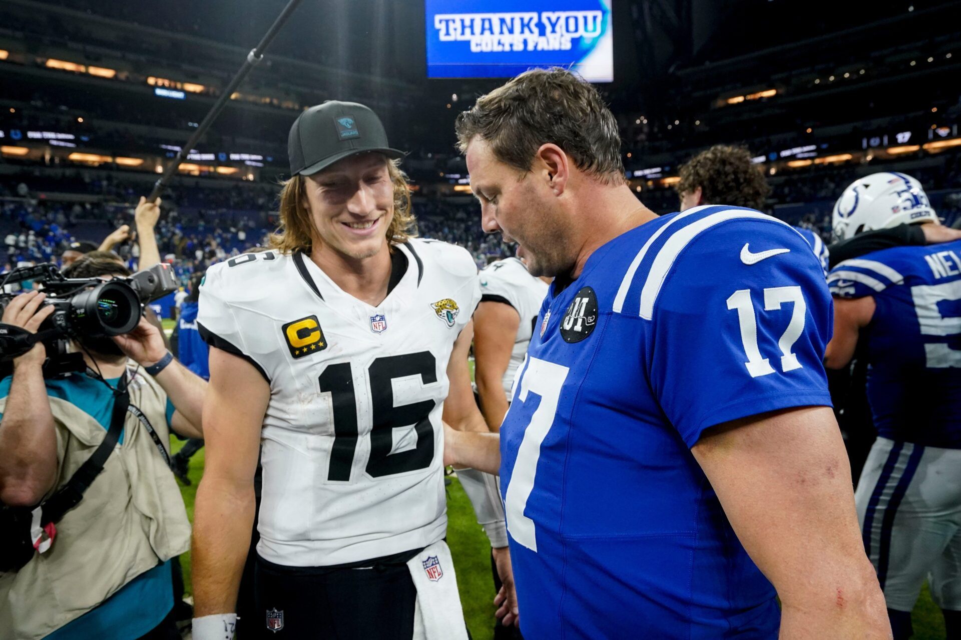 Jacksonville Jaguars quarterback Trevor Lawrence (16) and Indianapolis Colts quarterback Philip Rivers (17) meet on the field Sunday, Dec. 28, 2025, after the Jacksonville Jaguars defeated the Indianapolis Colts 23-17 at Lucas Oil Stadium in Indianapolis.