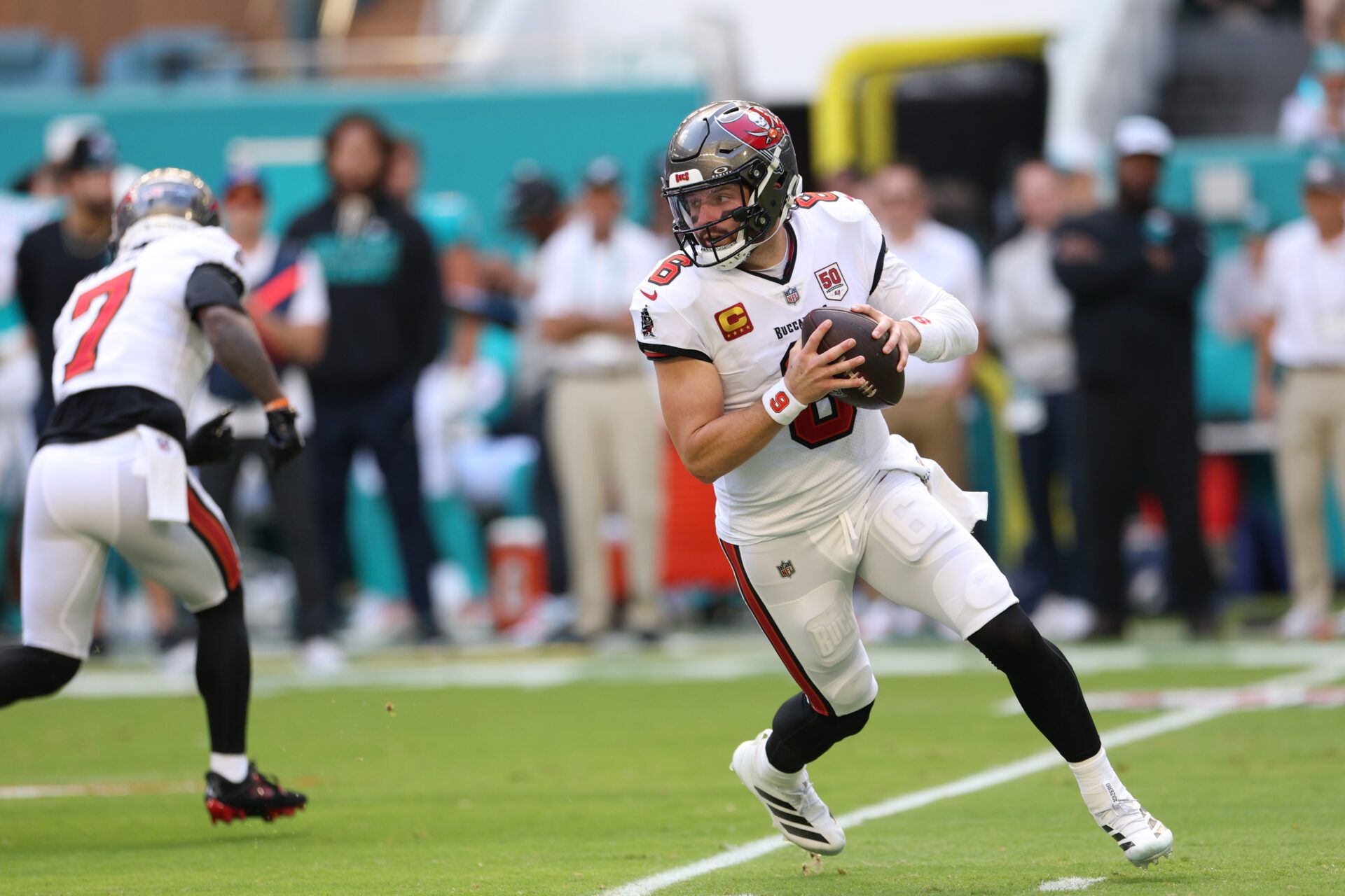Tampa Bay Buccaneers quarterback Baker Mayfield (6) runs in the pocket during the first quarter against the Miami Dolphins at Hard Rock Stadium.