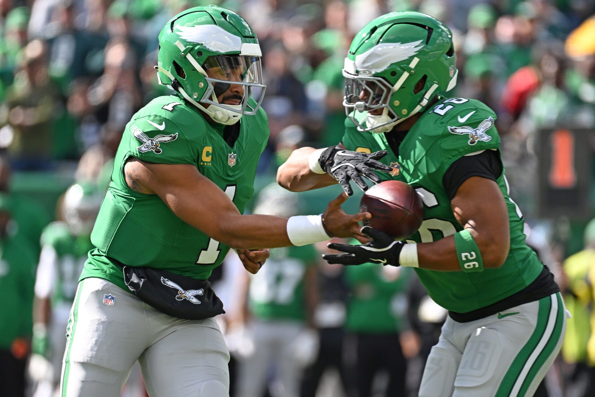 Philadelphia Eagles quarterback Jalen Hurts (1) hands off to running back Saquon Barkley (26) against the New York Giants at Lincoln Financial Field.
