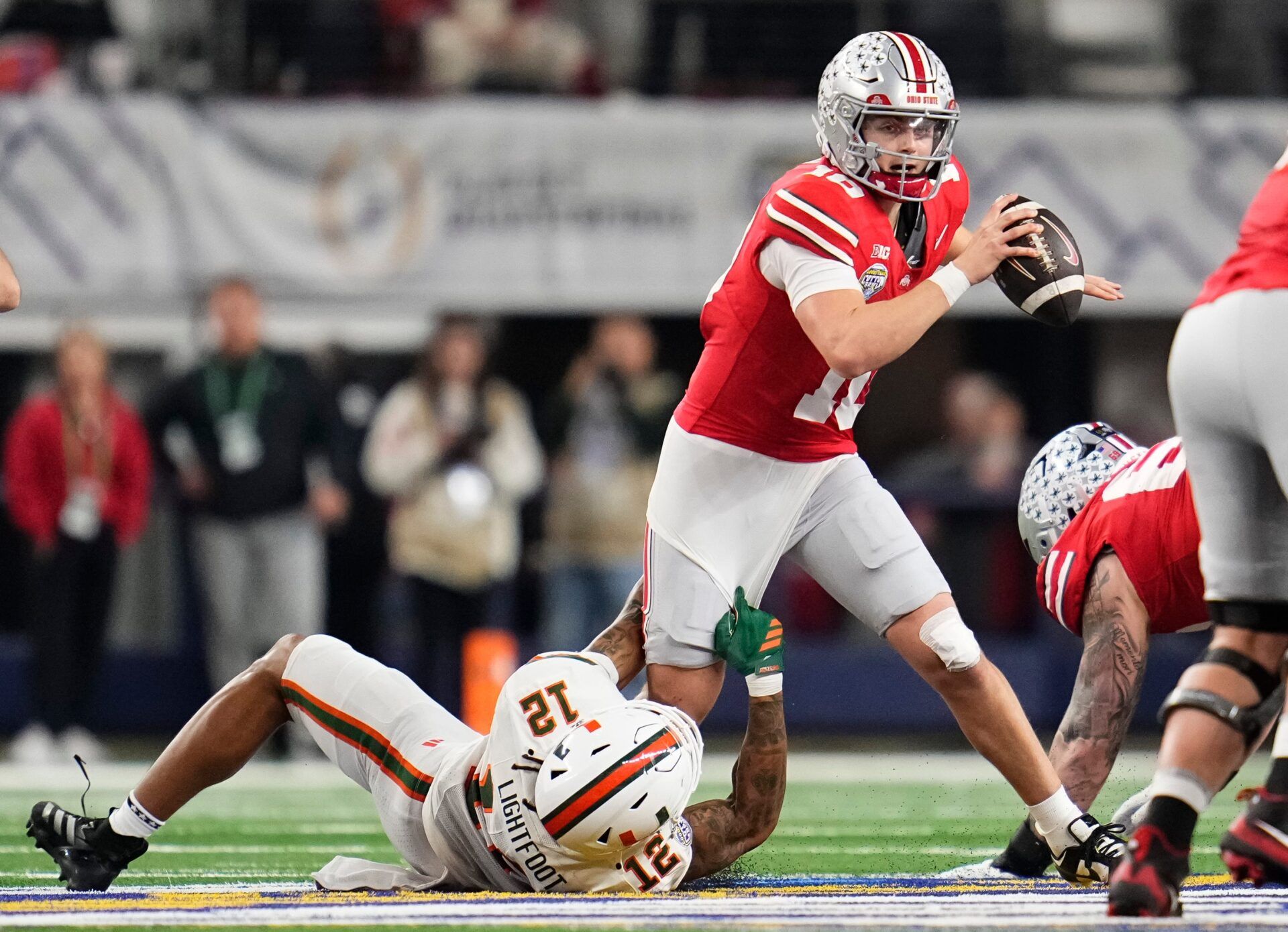 Miami Hurricanes defensive lineman Marquise Lightfoot (12) sacks Ohio State Buckeyes quarterback Julian Sayin (10) during the Cotton Bowl at AT&T Stadium in Arlington, Texas for the College Football Playoff quarterfinal game on Dec. 31, 2025. Ohio State lost 24-14.