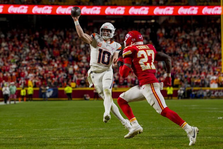 Denver Broncos quarterback Bo Nix (10) throws a toucdown pass during the fourth quarter at GEHA Field at Arrowhead Stadium.
