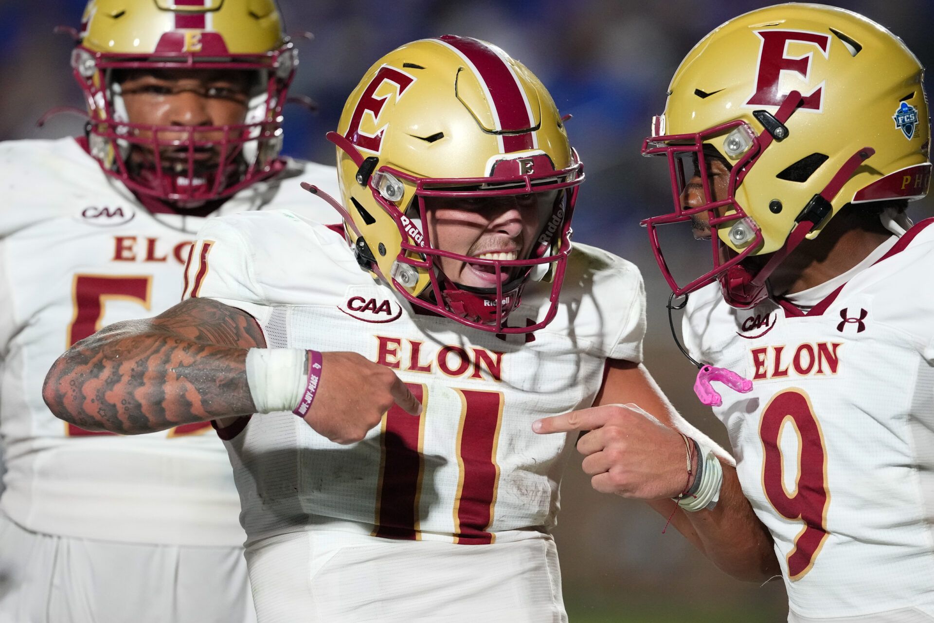 Elon Phoenix quarterback Landen Clark (11) celebrates his touchdown run with wide receiver Kenaz McMillian (9) against the Duke Blue Devils during the first half at Wallace Wade Stadium.