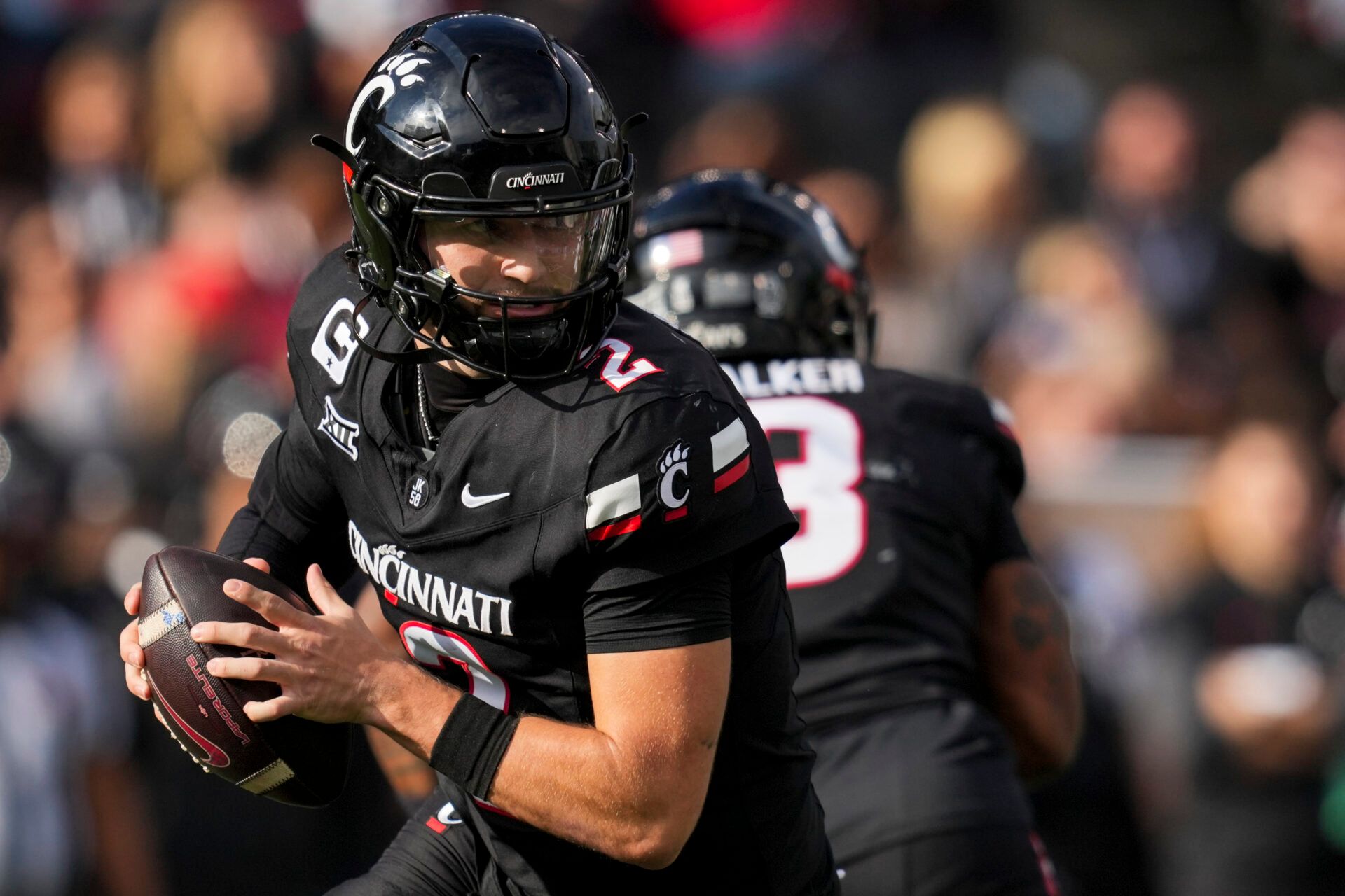 Cincinnati Bearcats quarterback Brendan Sorsby (2) runs with the ball as he looks to pass against the Arizona Wildcats in the second half at Nippert Stadium.