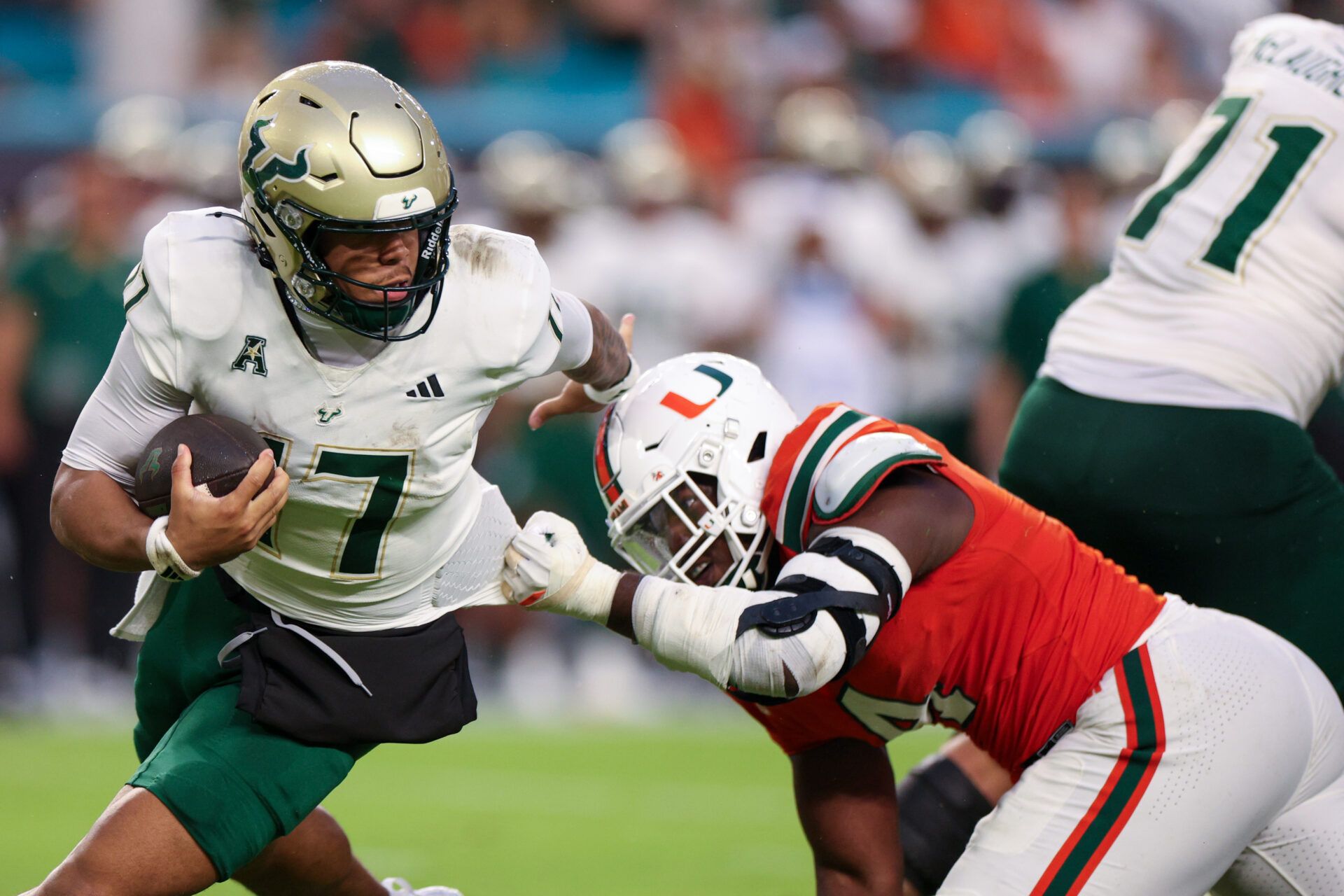 South Florida Bulls quarterback Byrum Brown (17) scrambles out of the pocket against the Miami Hurricanes in the second quarter at Hard Rock Stadium.