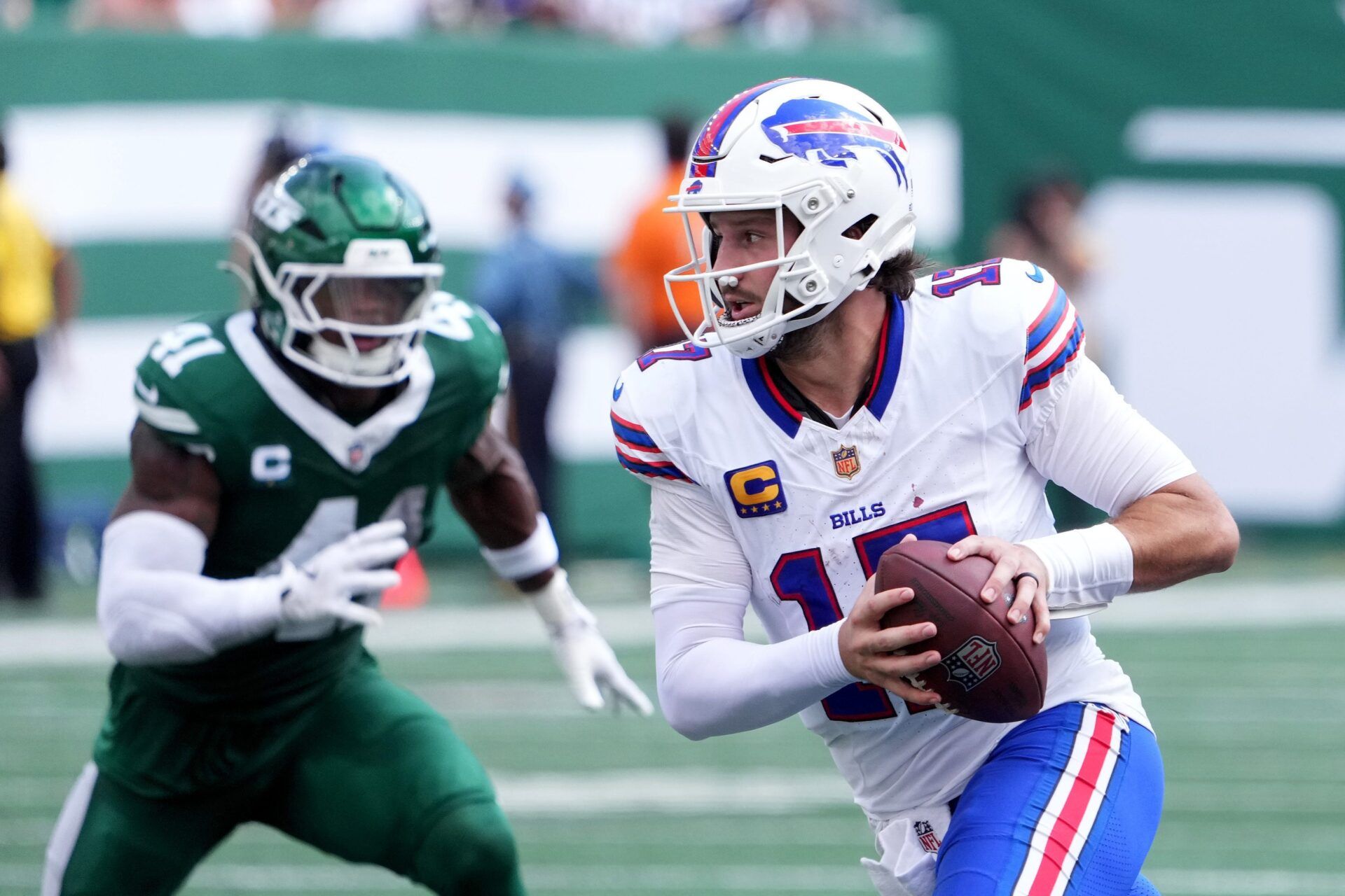 Buffalo Bills quarterback Josh Allen (17) rushes the ball past New York Jets linebacker Marcelino McCrary-Ball (41) during the first half at MetLife Stadium.