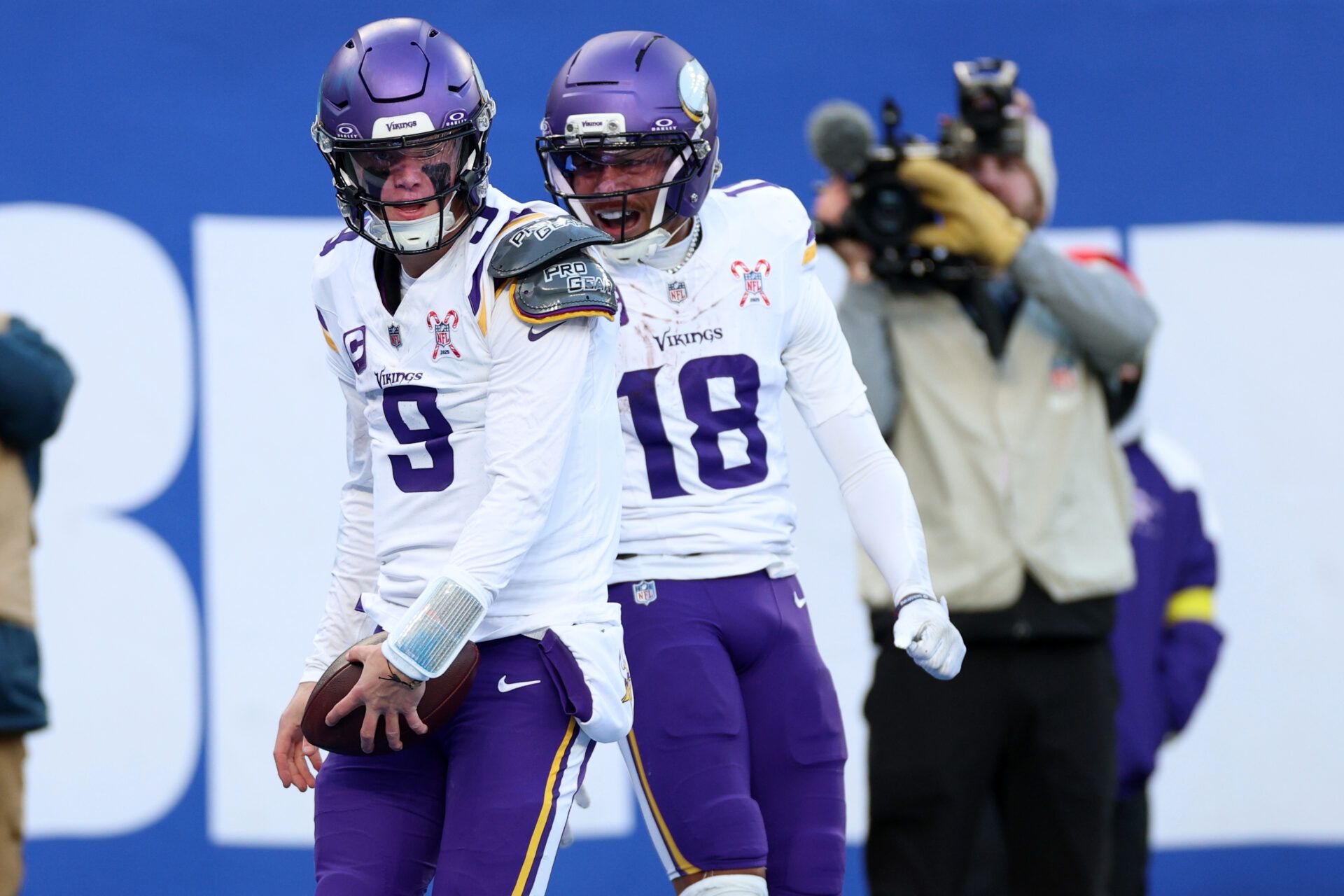 Minnesota Vikings quarterback J.J. McCarthy (9) reacts with wide receiver Justin Jefferson (18) after rushing for a touchdown against the New York Giants during the first half at MetLife Stadium.