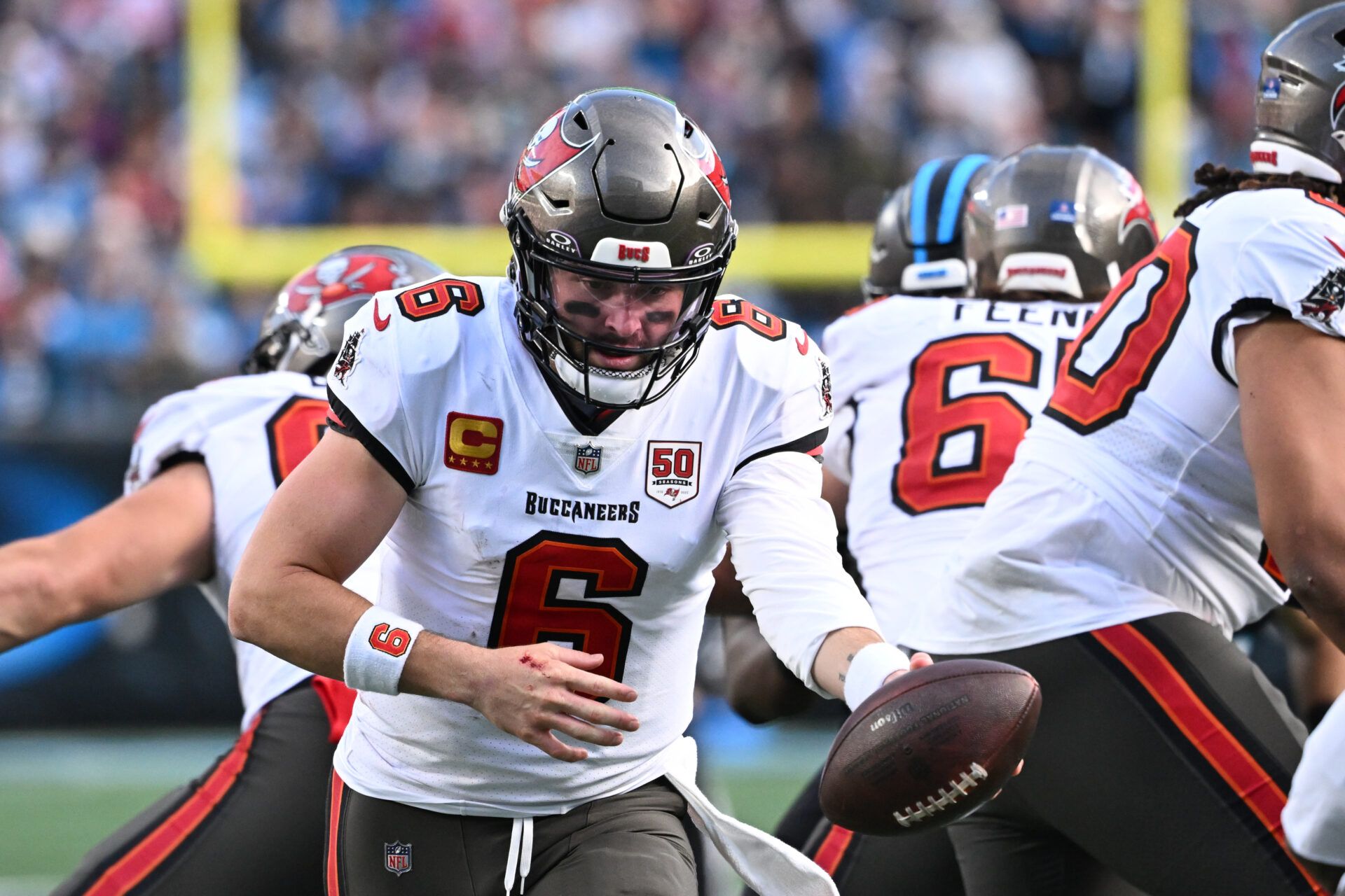 Tampa Bay Buccaneers quarterback Baker Mayfield (6) fakes a hand off in the fourth quarter at Bank of America Stadium.