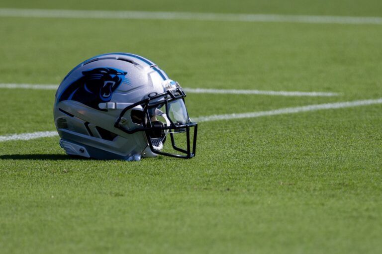 A Carolina Panthers helmet sits on the ground at training camp.