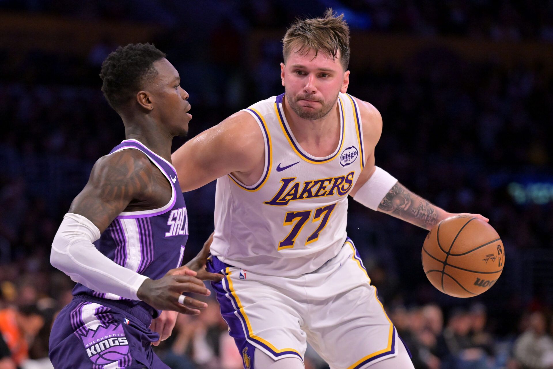 Sacramento Kings guard Dennis Schroder (17) defemds Los Angeles Lakers guard Luka Doncic (77) in the second half at Crypto.com Arena.
