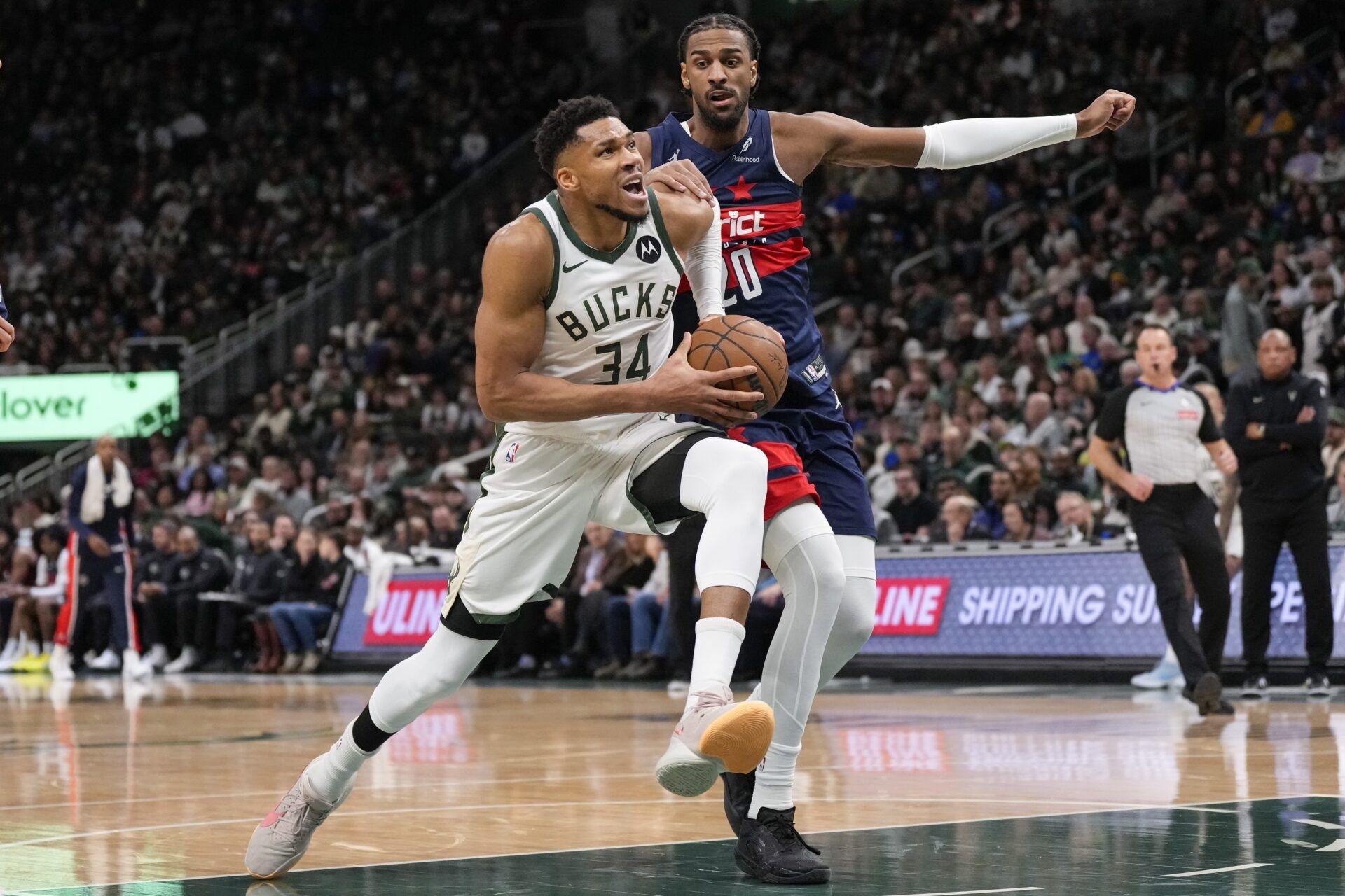 Milwaukee Bucks forward Giannis Antetokounmpo (34) drives for the basket in front of Washington Wizards forward Alexandre Sarr (20) during the second quarter at Fiserv Forum.