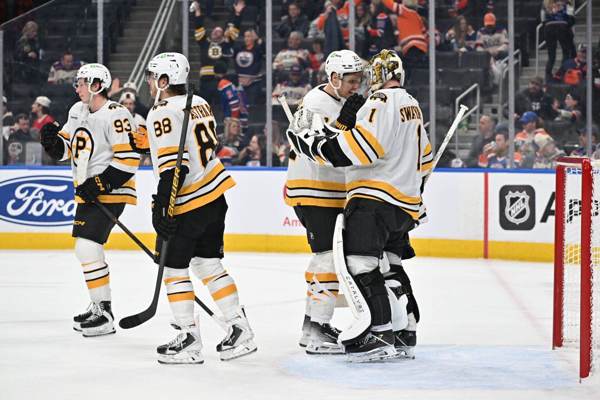 Boston Bruins right winger David Pastrnak (88) center Fraser Minten (93) defenseman Hampus Lindholm (27) and goalie Jeremy Swayman (1) celebrate a win over the Edmonton Oilers at Rogers Place.