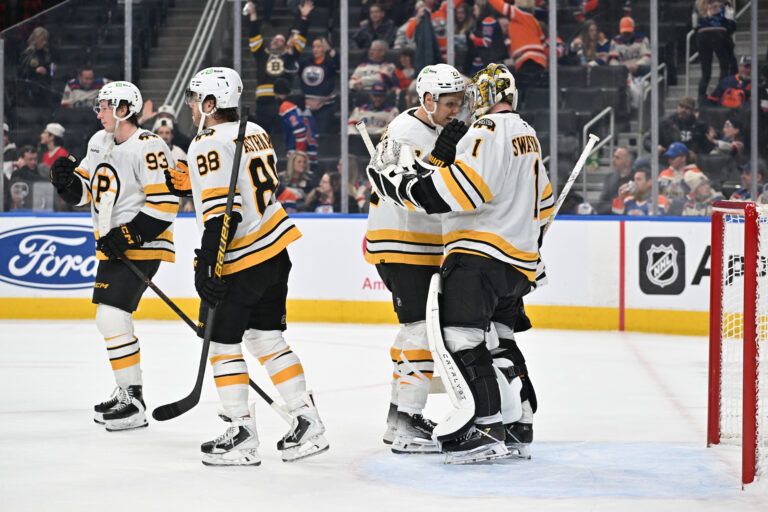 Boston Bruins right winger David Pastrnak (88) center Fraser Minten (93) defenseman Hampus Lindholm (27) and goalie Jeremy Swayman (1) celebrate a win over the Edmonton Oilers at Rogers Place.