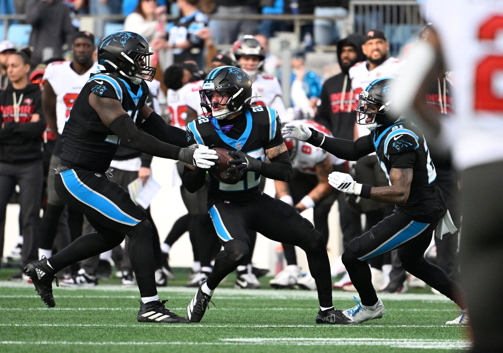 Carolina Panthers safety Lathan Ransom (22) celebrates with linebacker Nic Scourton (11) and safety Nick Scott (21) after intercepting the ball to seal the victory in the fourth quarter at Bank of America Stadium.