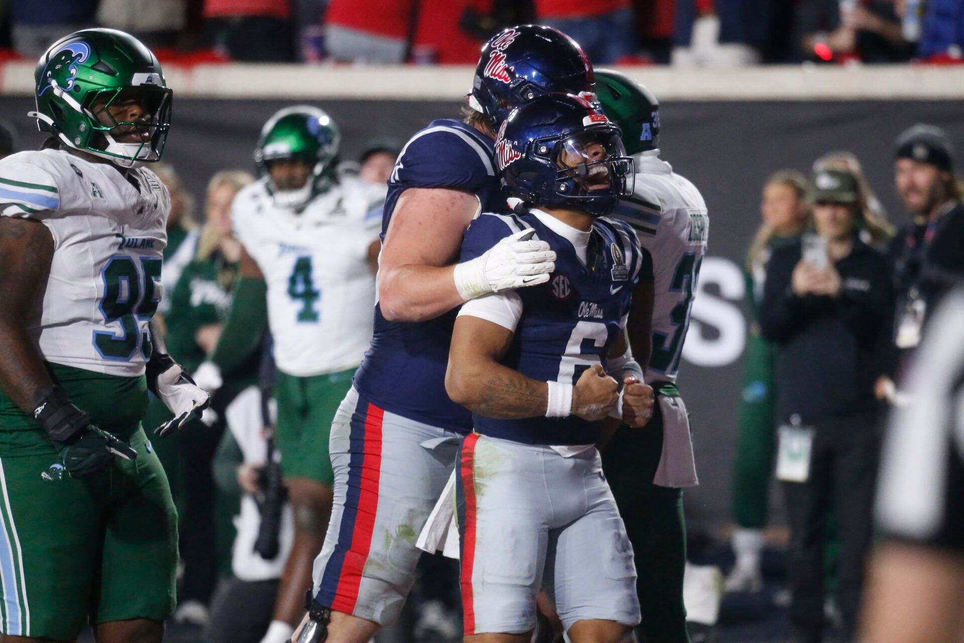 Mississippi Rebels quarterback Trinidad Chambliss (6) reacts with teammates after scoring a touchdown against the Tulane Green Wave during the second half of a game at Vaught-Hemingway Stadium.
