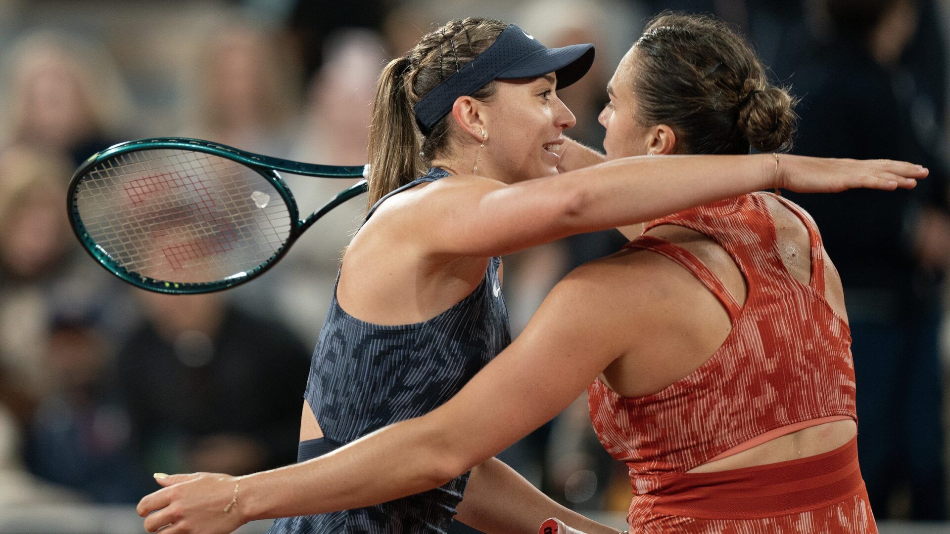 Aryna Sabalenka at the net with Paula Badosa of Spain after their match on day seven of Roland Garros at Stade Roland Garros.