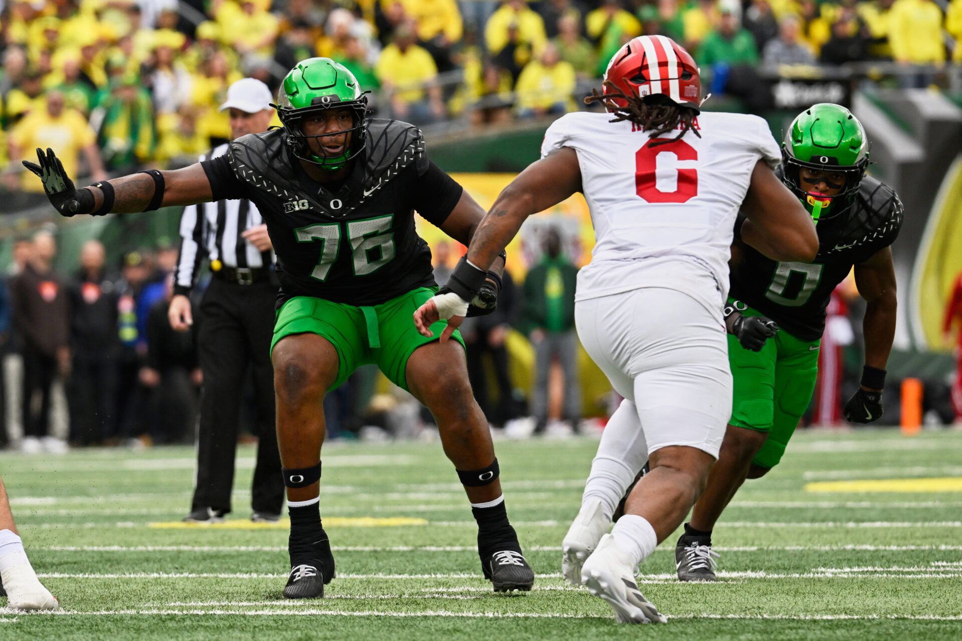 Oregon Ducks offensive lineman Isaiah World (76) and defensive back Daylen Austin (0) block against Indiana Hoosiers defensive lineman Mikail Kamara (6) during the second quarter   at Autzen Stadium.