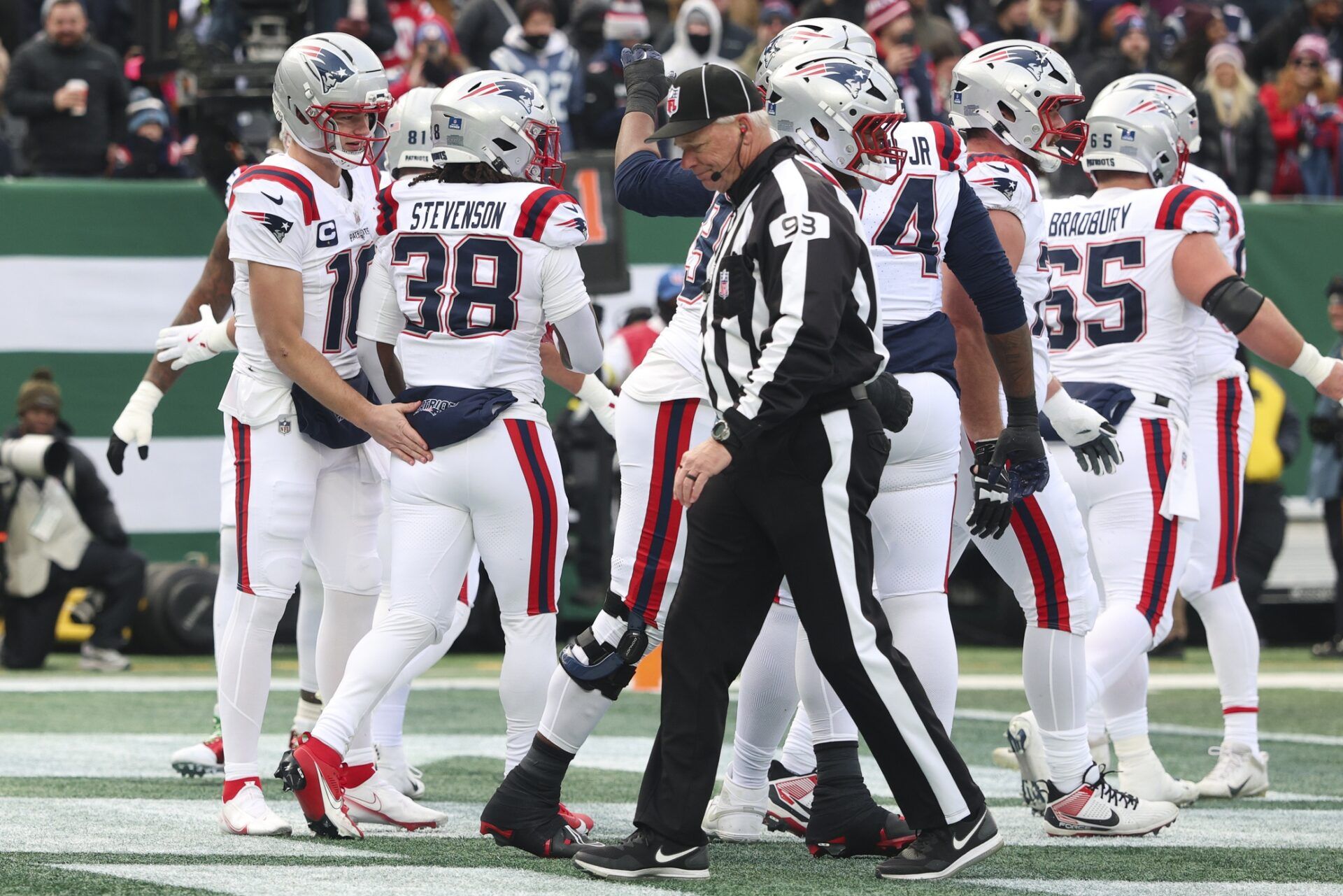 New England Patriots running back Rhamondre Stevenson (38) celebrates a rushing touchdown against the New York Jets with teammates during the first quarter of the game at MetLife Stadium.