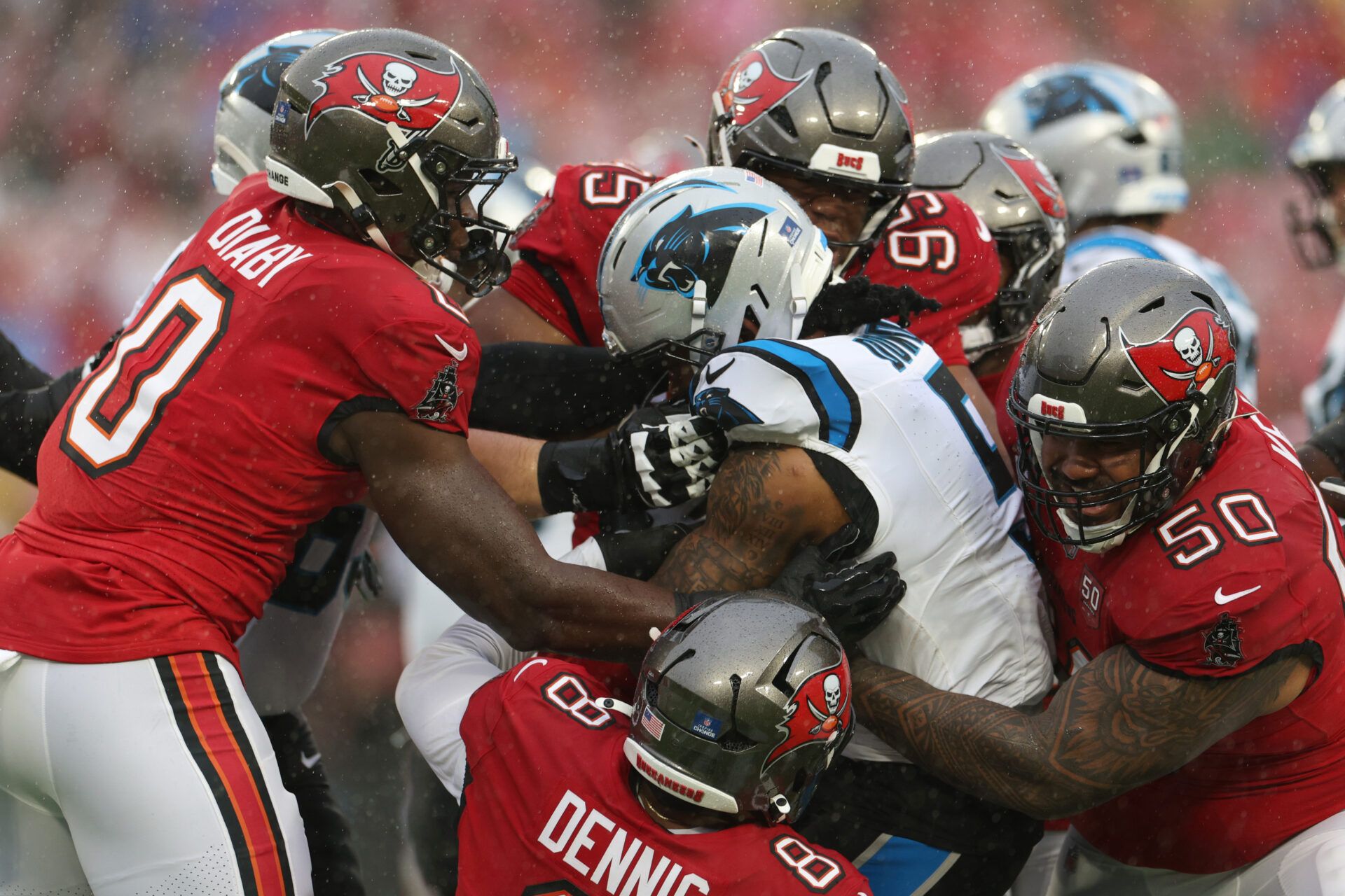 Tampa Bay Buccaneers linebacker Sirvocea Dennis (8) and linebacker Yaya Diaby (0) and defensive end Elijah Roberts (95) and defensive tackle Vita Vea (50) tackle Carolina Panthers running back Rico Dowdle (5) in the first half at Raymond James Stadium.