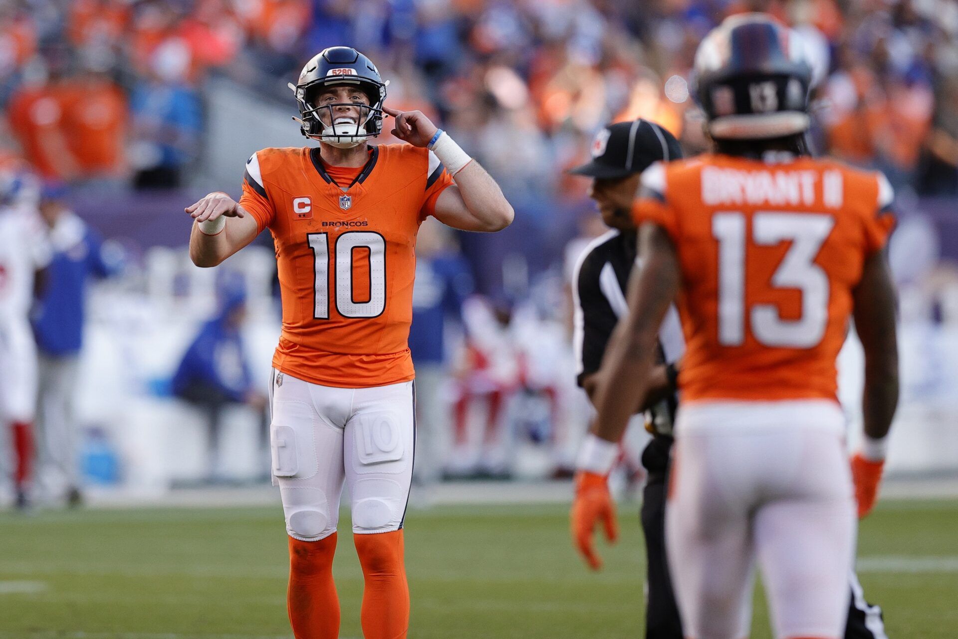 Denver Broncos quarterback Bo Nix (10) reacts after a play against the New York Giants during the second half at Empower Field at Mile High.