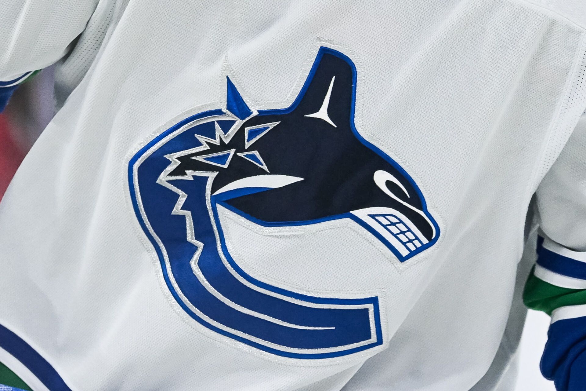 View of a Vancouver Canucks logo on a jersey worn by a member of the team at Bell Centre.