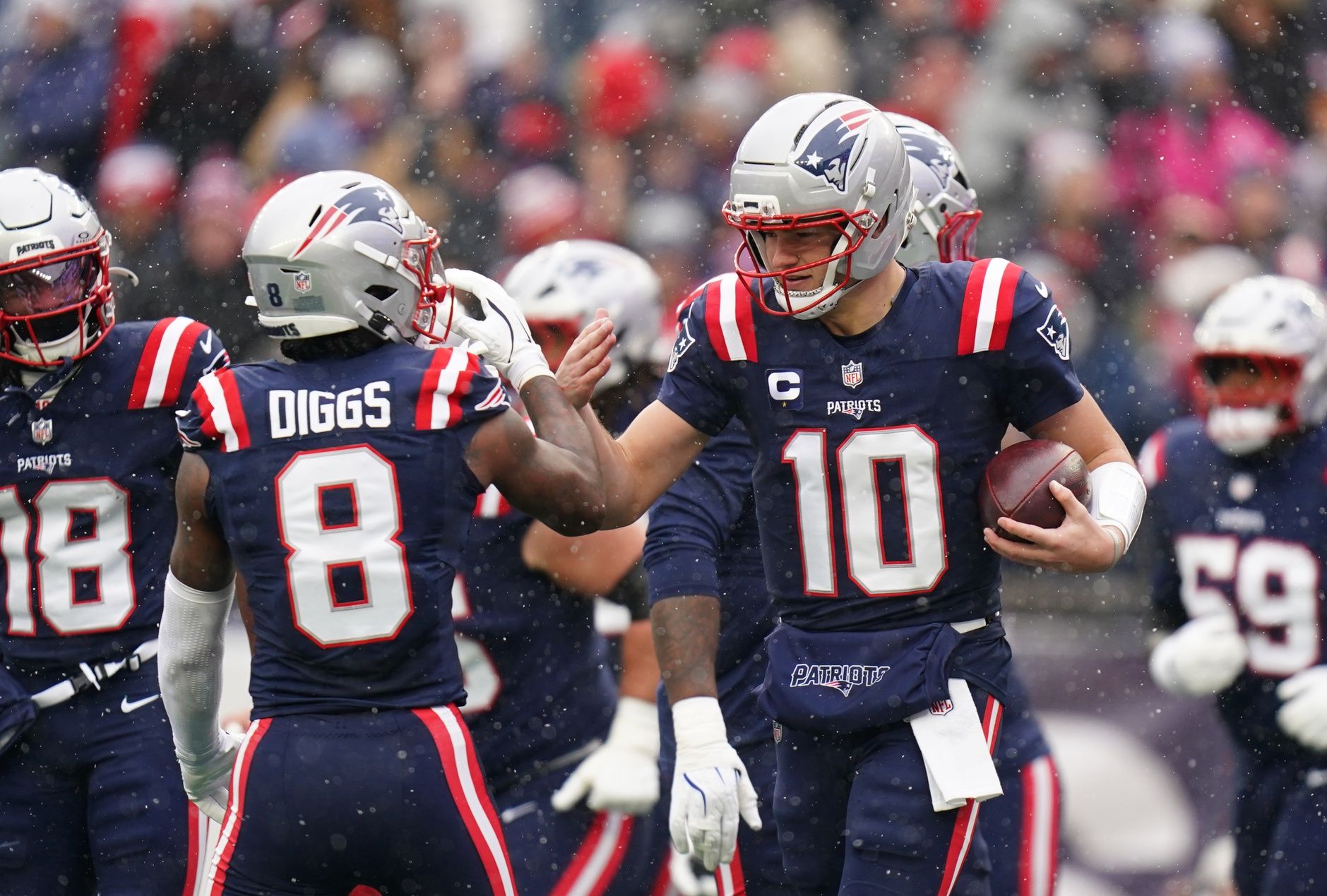 New England Patriots quarterback Drake Maye (10) reacts with wide receiver Stefon Diggs (8) after running the ball for a touchdown against the Buffalo Bills in the first quarter at Gillette Stadium.