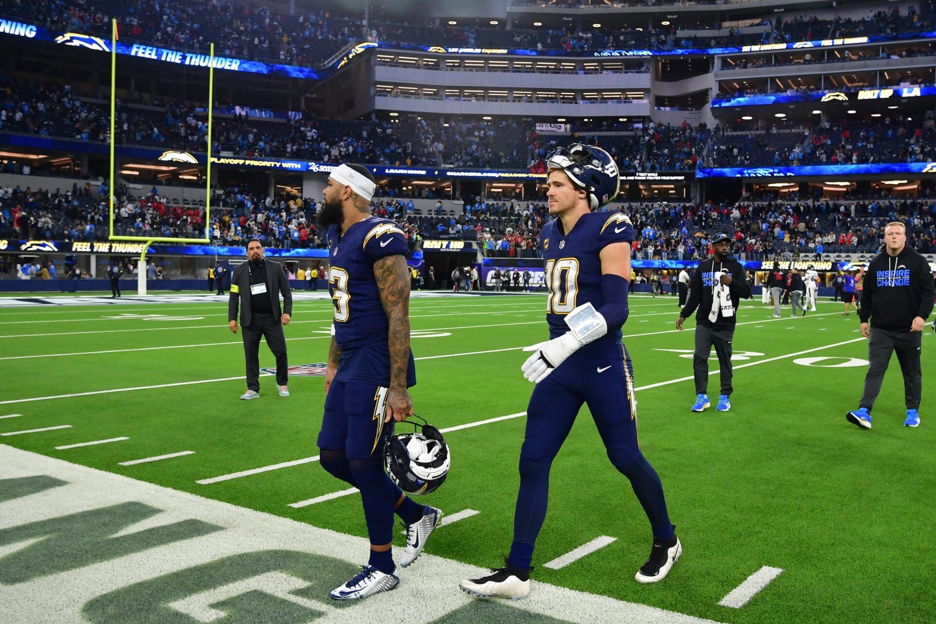 Los Angeles Chargers wide receiver Keenan Allen (13) and quarterback Justin Herbert (10) leave the field following a game against the Houston Texans at SoFi Stadium.