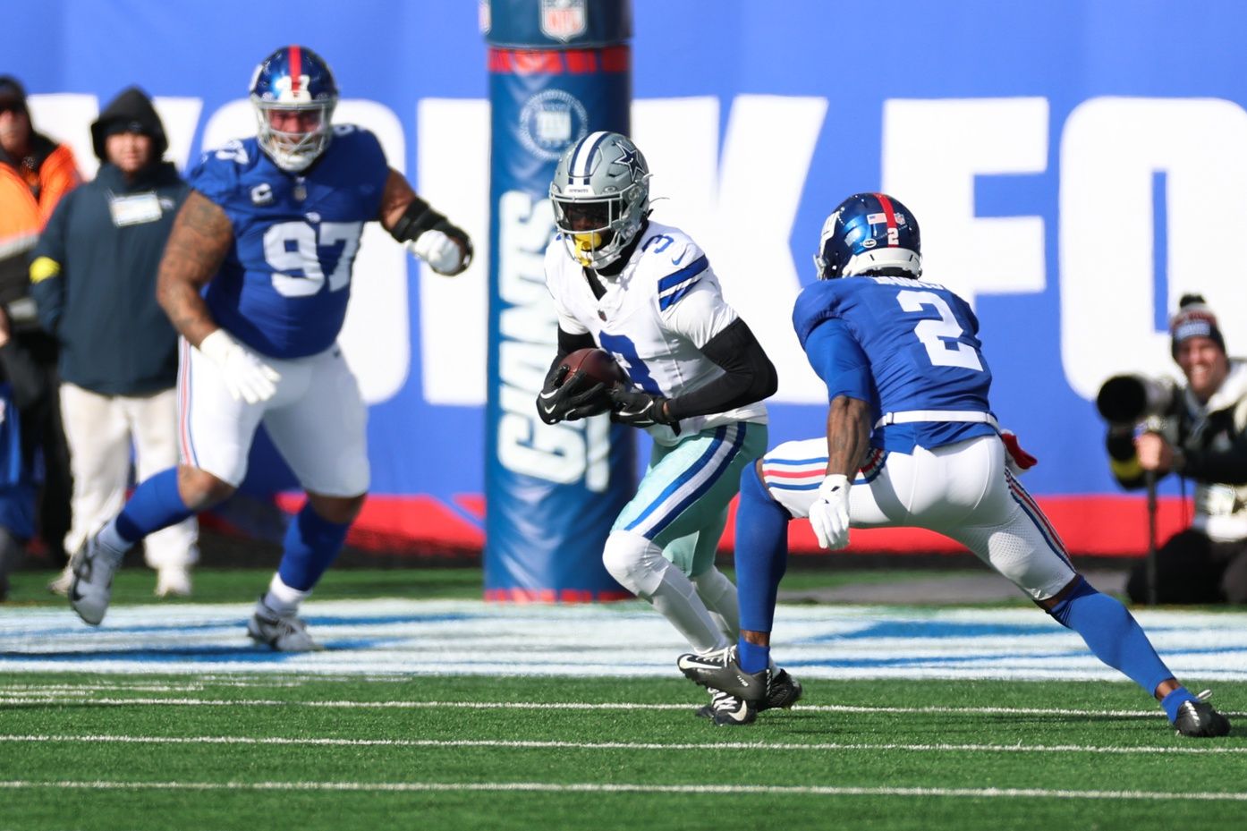 Dallas Cowboys wide receiver George Pickens (3) runs after making a catch as New York Giants cornerback Deonte Banks (2) defends during the first quarter at MetLife Stadium.