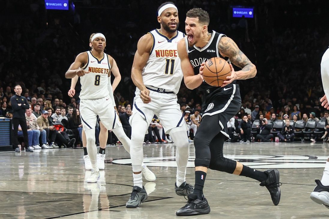 Brooklyn Nets forward Michael Porter Jr. (17) looks to drive past Denver Nuggets guard Bruce Brown (11) in the third quarter at Barclays Center.
