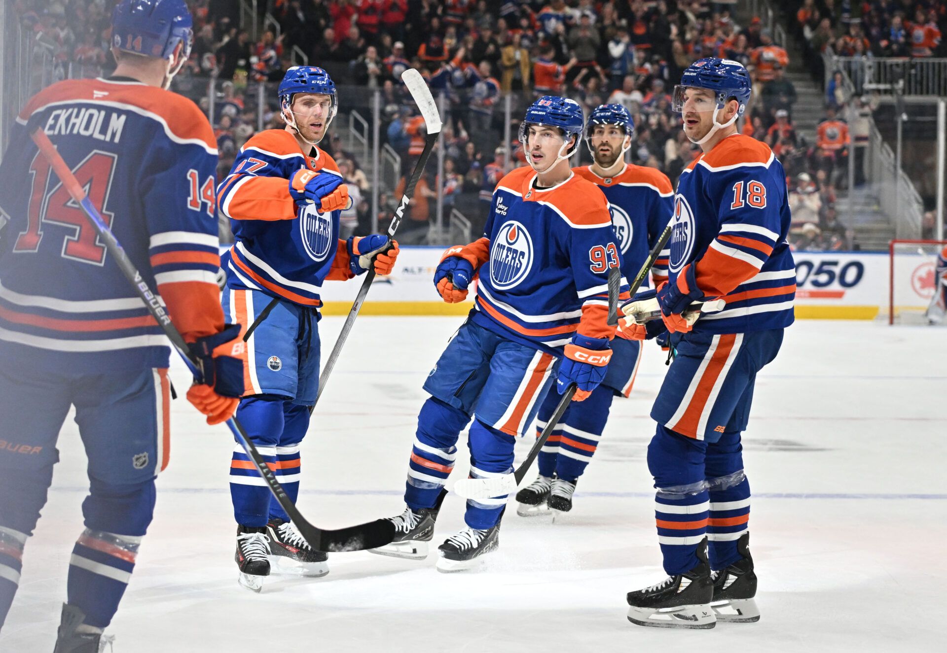 Edmonton Oilers center Connor McDavid (97) is congratulated by defenseman Mattias Ekholm (14), center Ryan Nugent-Hopkins (93) and left winger Zach Hyman (18) at Rogers Place.