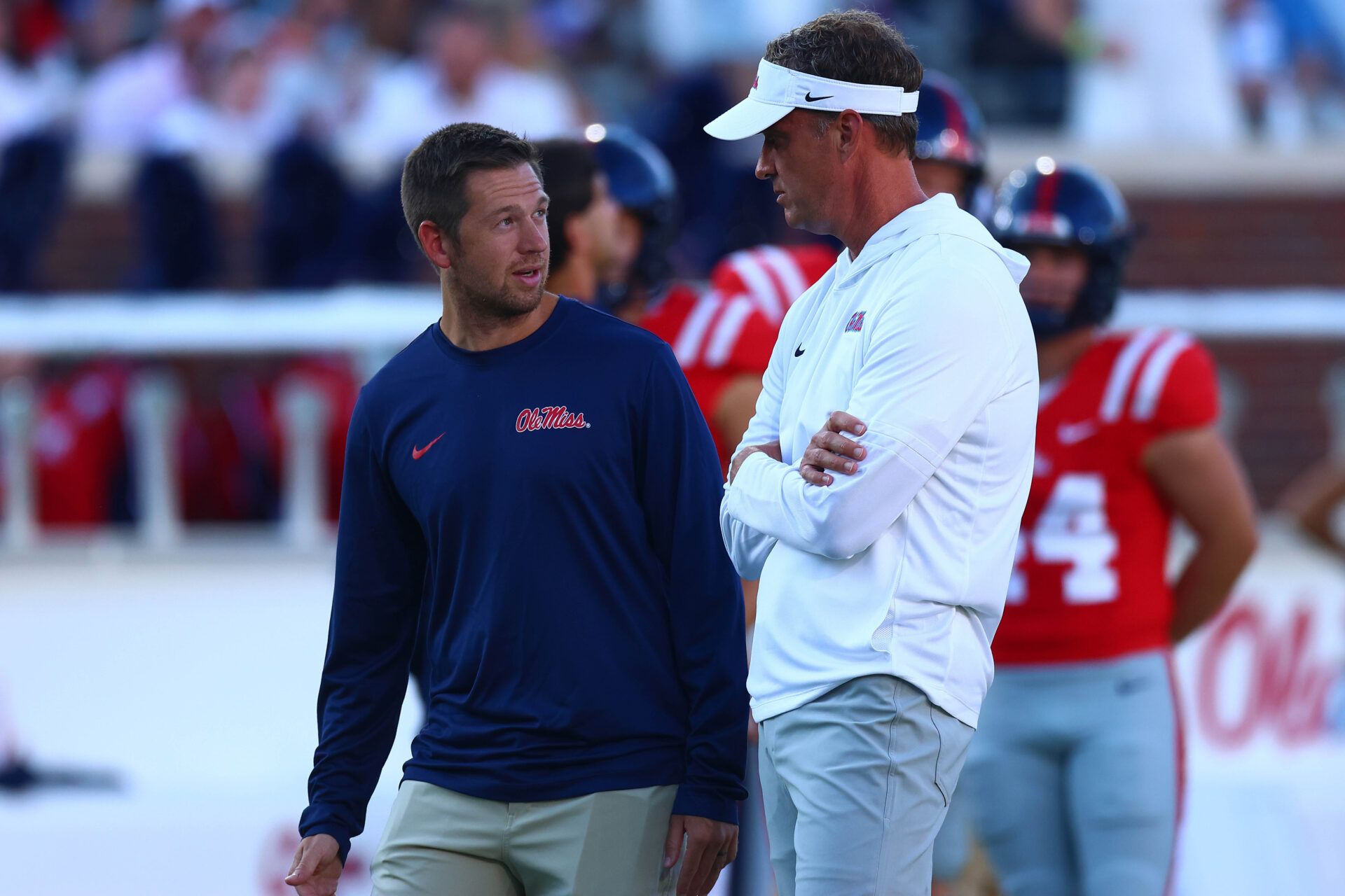 Mississippi Rebels head coach Lane Kiffin (right) talks with offensive coordinator Charlie Weis Jr. during warm ups prior to the game against the Georgia State Panthers at Vaught-Hemingway Stadium.