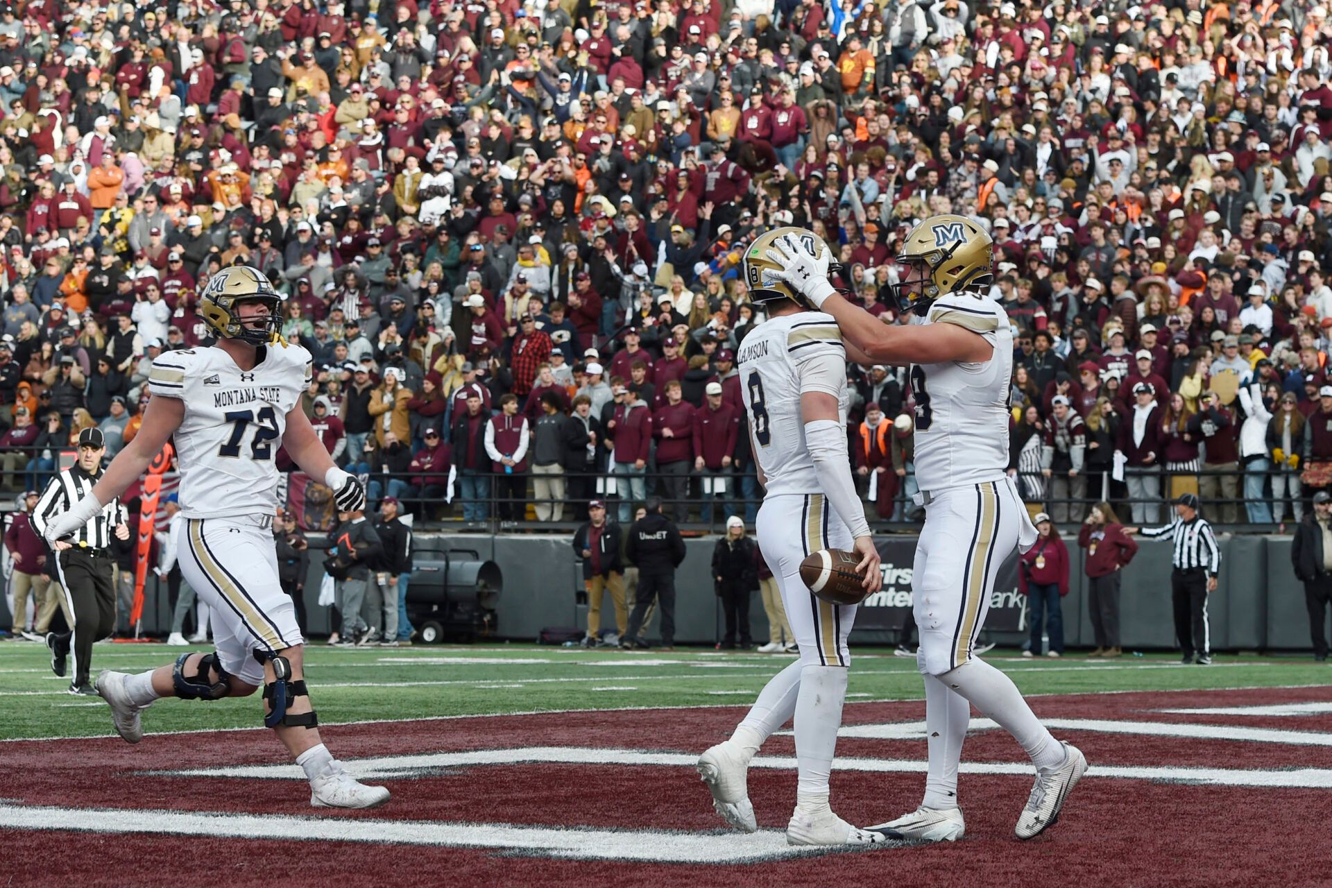 Montana State Bobcats quarterback Justin Lamson (8) celebrates with tight end Rocky Lencioni (89) and offensive lineman Braden Zimmer (72) after his rushing touchdown during the second half at Washington-Grizzly Stadium.