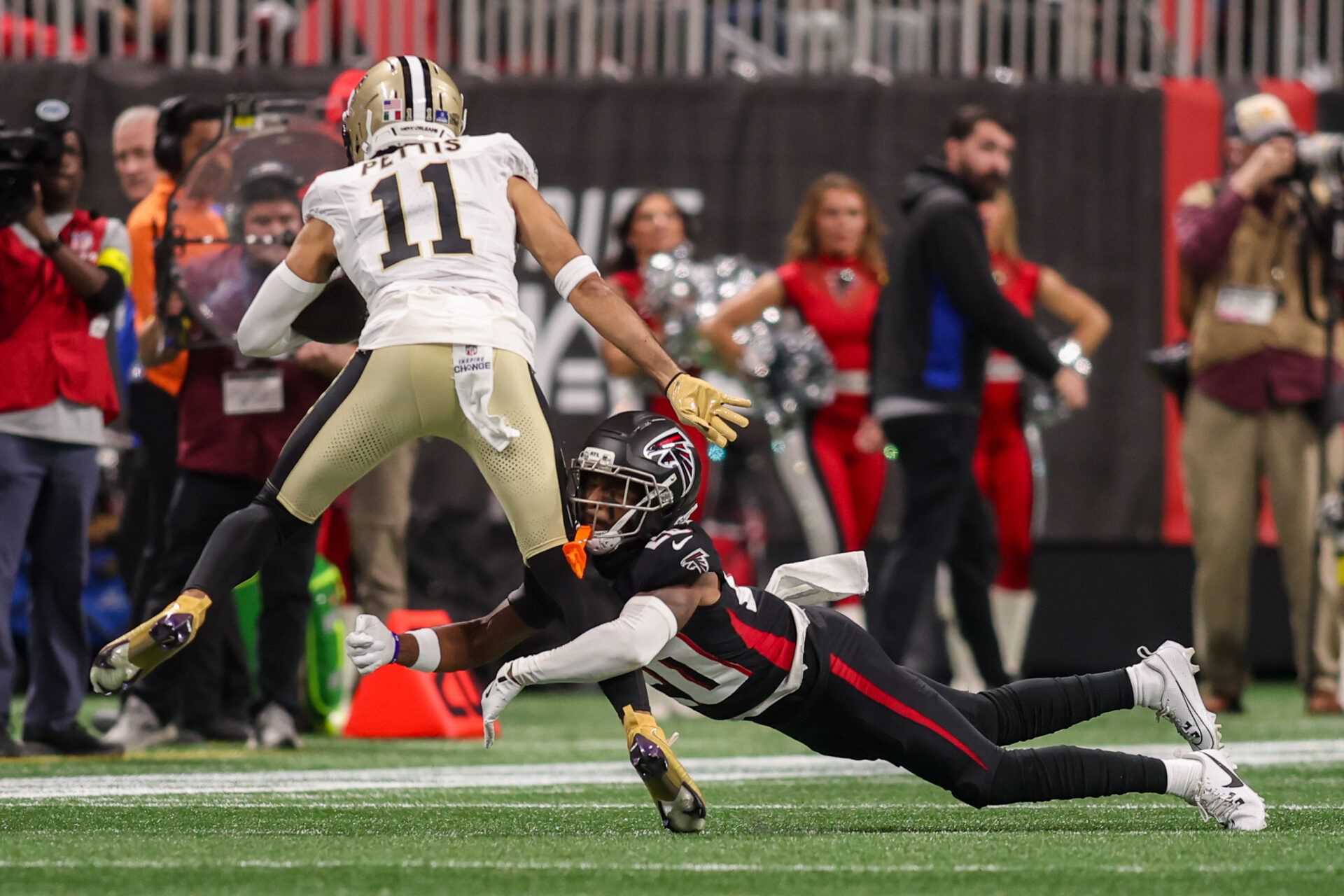Atlanta Falcons cornerback Dee Alford (20) tackles New Orleans Saints wide receiver Dante Pettis (11) in the first quarter at Mercedes-Benz Stadium.