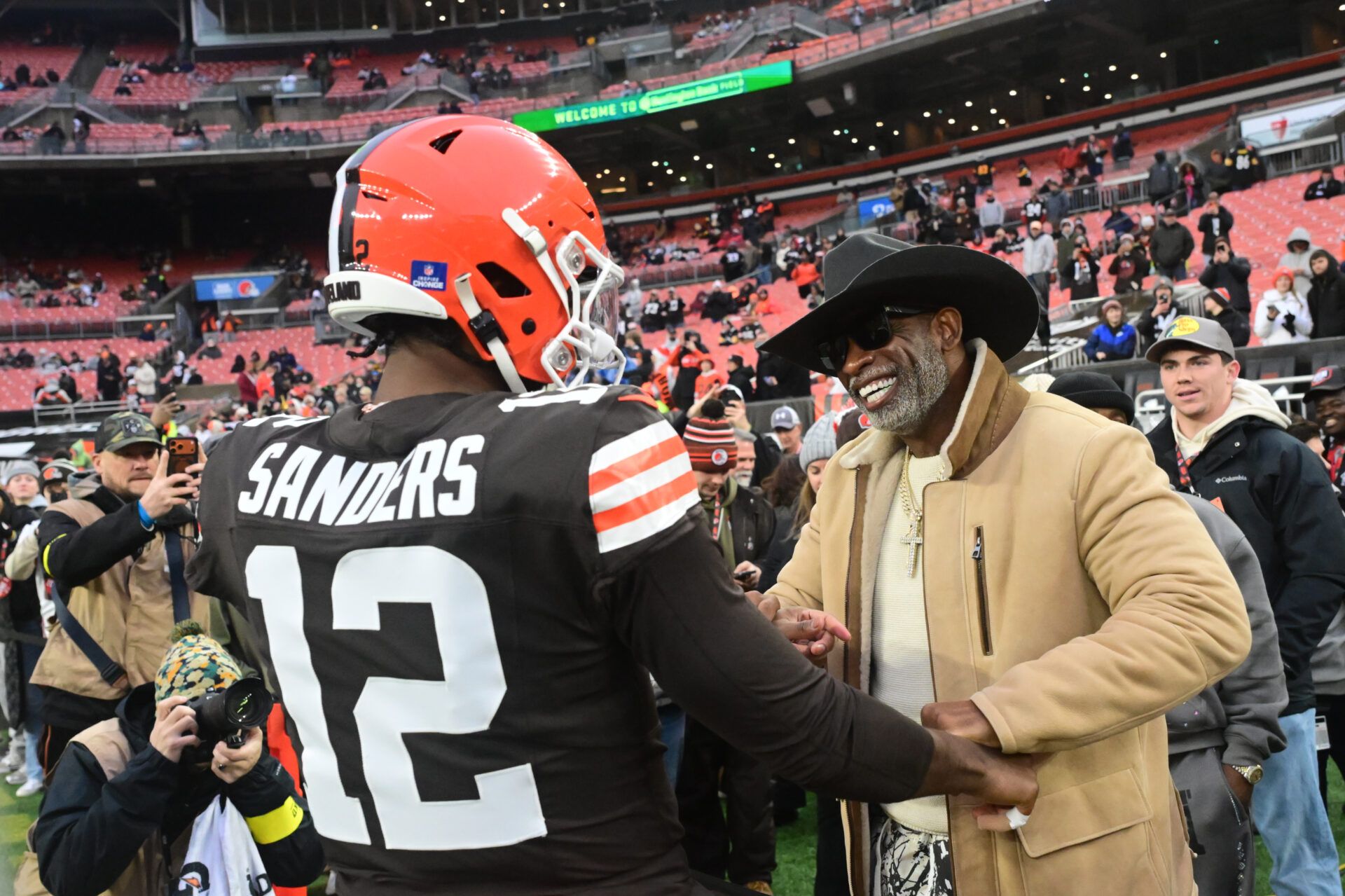 Cleveland Browns quarterback Shedeur Sanders (12) and his father Deion Sanders on the sideline before the game against the Pittsburgh Steelers at Huntington Bank Field.