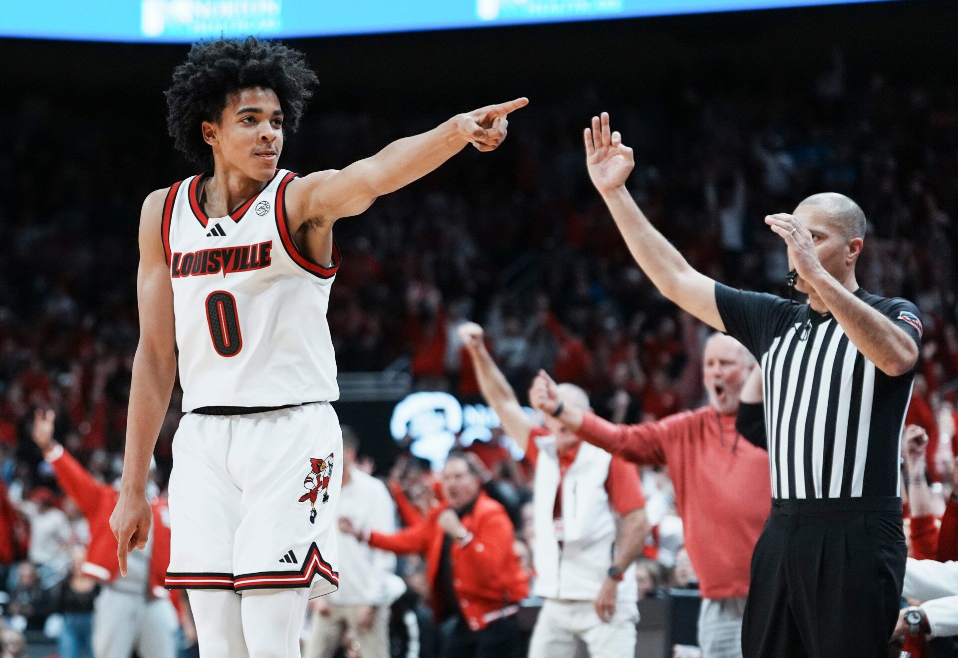Louisville Cardinals guard Mikel Brown Jr. (0) celebrates his three-point shot as the Cards go up over Kentucky in the first half during the UofL-UK annual rivalry game at the KFC Yum! Center in Louisville, Kentucky Nov. 11, 2025.