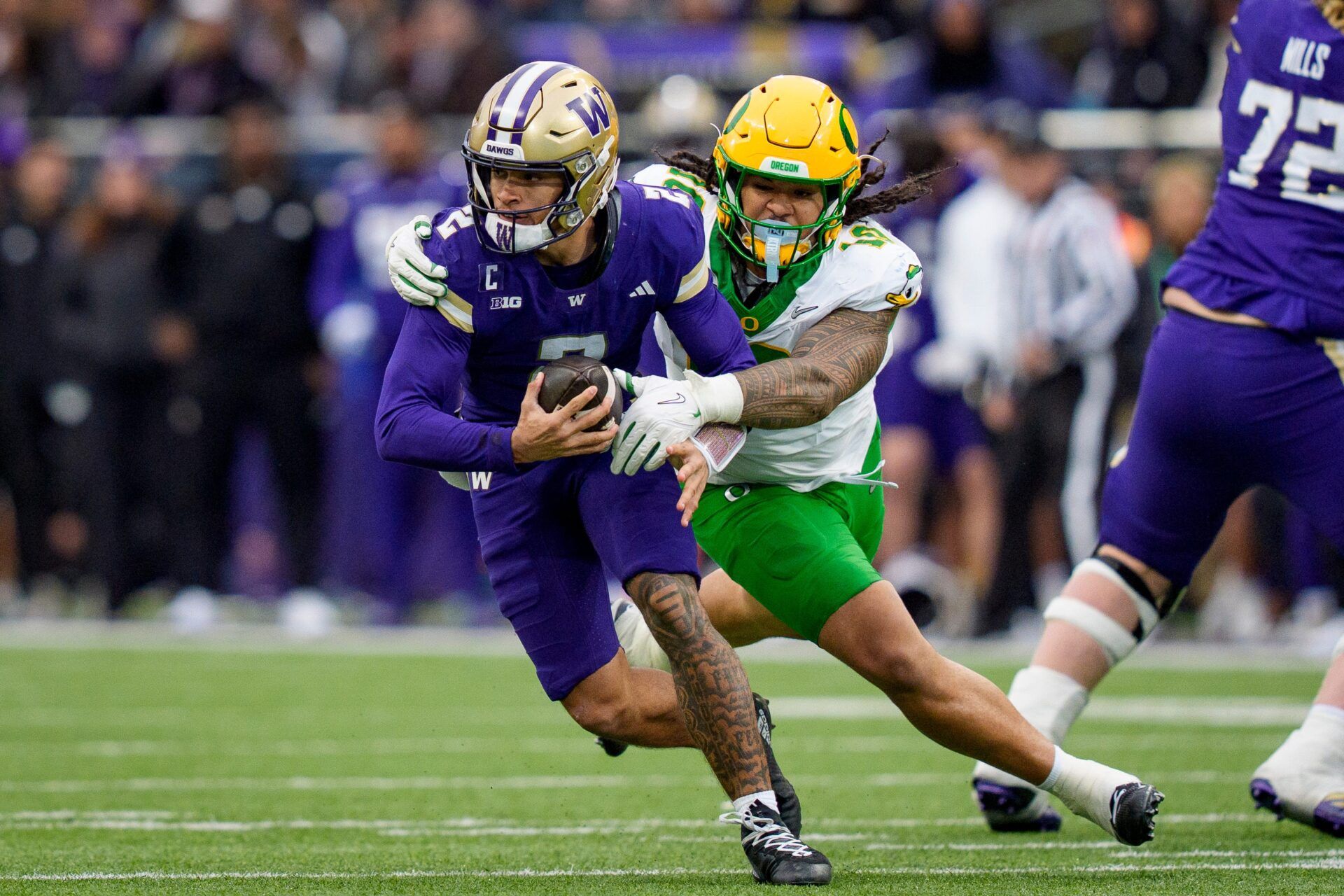 Oregon outside linebacker Matayo Uiagalelei, right, pressures Washington quarterback Demond Williams Jr. as the Oregon Ducks take on the Washington Huskies on Nov. 29, 2025, at Husky Stadium in Seattle, Washington.