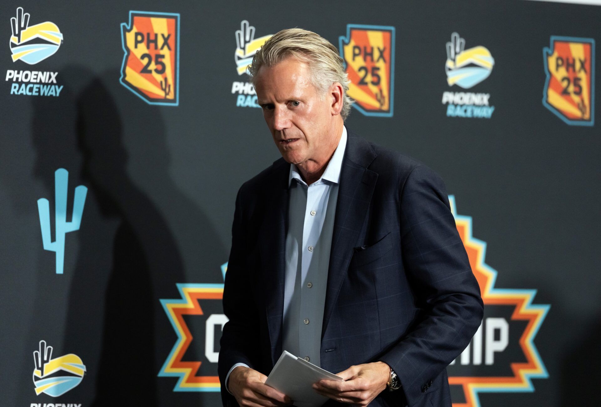 NASCAR commissioner Steve Phelps walks off the stage following the state of the sport press conference in the media center at Phoenix Raceway.