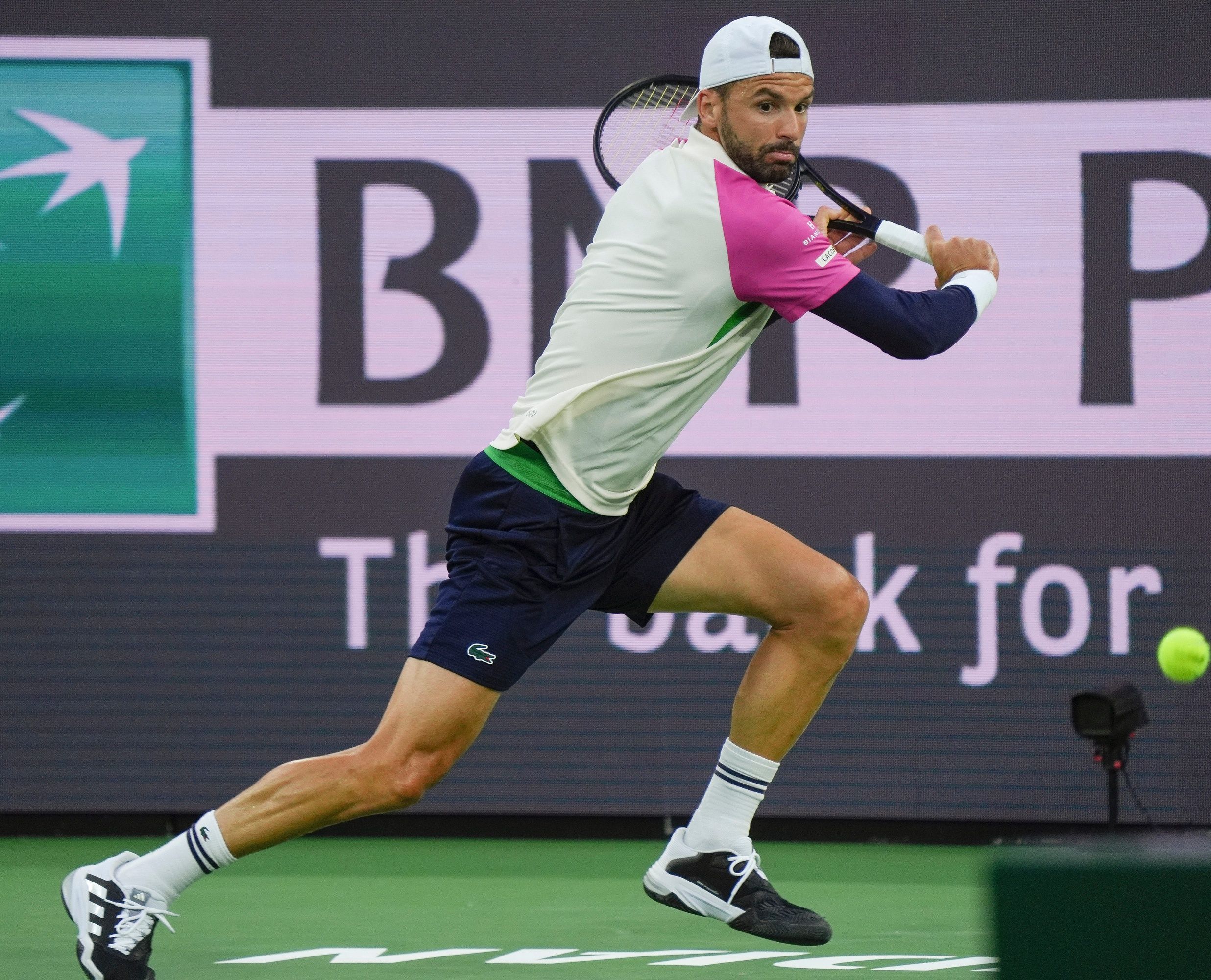 Grigor Dimitrov runs down a shot against Carlos Alcaraz during Round 4 of the BNP Paribas Open in Indian Wells, Calif., March 12, 2025.