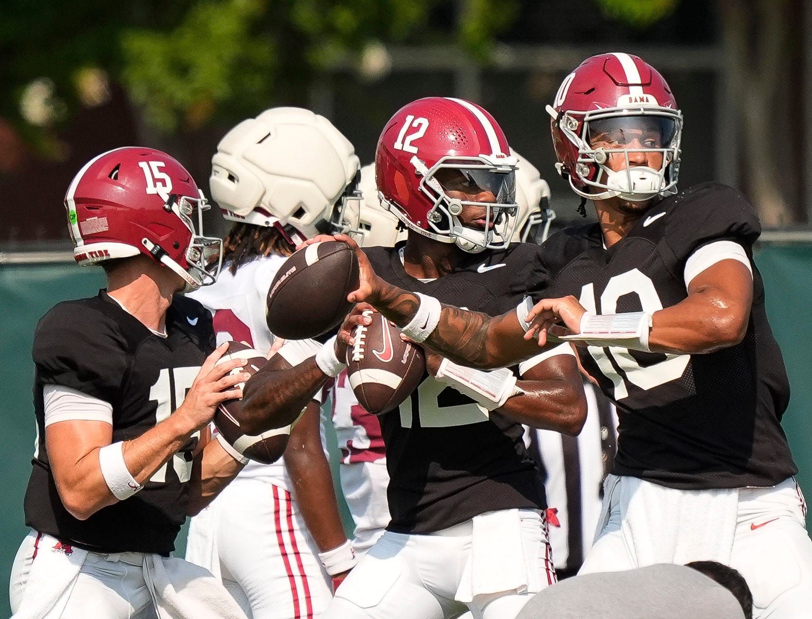 Aug. 19, 2025, Tuscaloosa, AL; Quarterbacks Austin Mack (10), Keelon Russell (12), and Ty Simpson (15) throw during practice for the Alabama Crimson Tide.