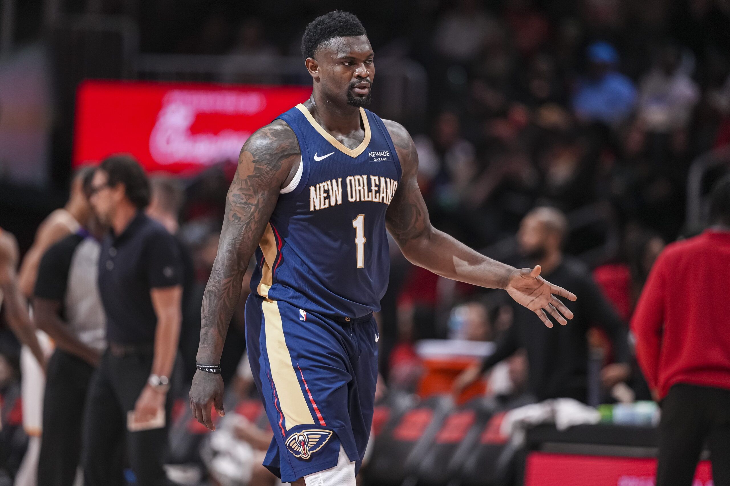 New Orleans Pelicans forward Zion Williamson (1) reacts on his way to the bench during a timeout against the Atlanta Hawks during the first half at State Farm Arena.