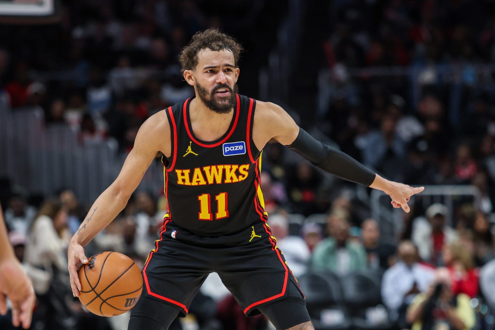 Atlanta Hawks guard Trae Young (11) points to teammates during the game against the Miami Heat during the third quarter at State Farm Arena.