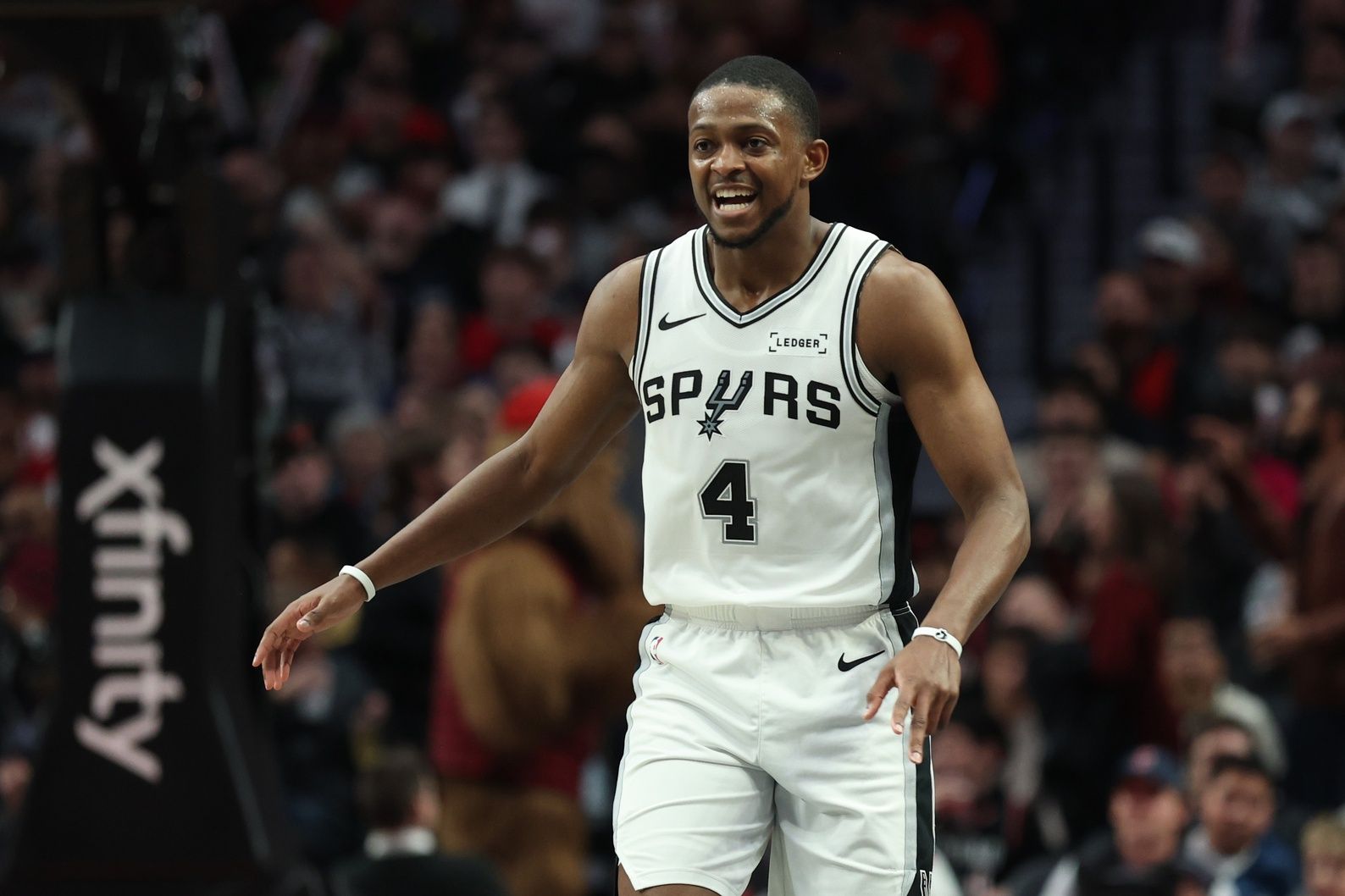 San Antonio Spurs guard De'Aaron Fox (4) reacts after making a three-point shot in the second half against the Portland Trail Blazers at Moda Center.