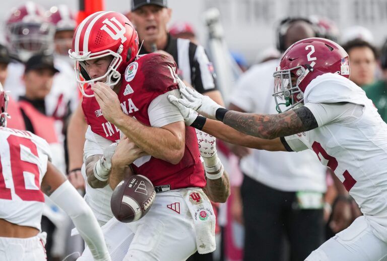 Indiana Hoosiers quarterback Fernando Mendoza (15) loses control of the ball against Alabama Crimson Tide defensive back Zabien Brown (2) on Thursday, Jan. 1, 2026, during the 112th annual Rose Bowl game in Pasadena. Indiana Hoosiers defeated Alabama Crimson Tide, 38-3.