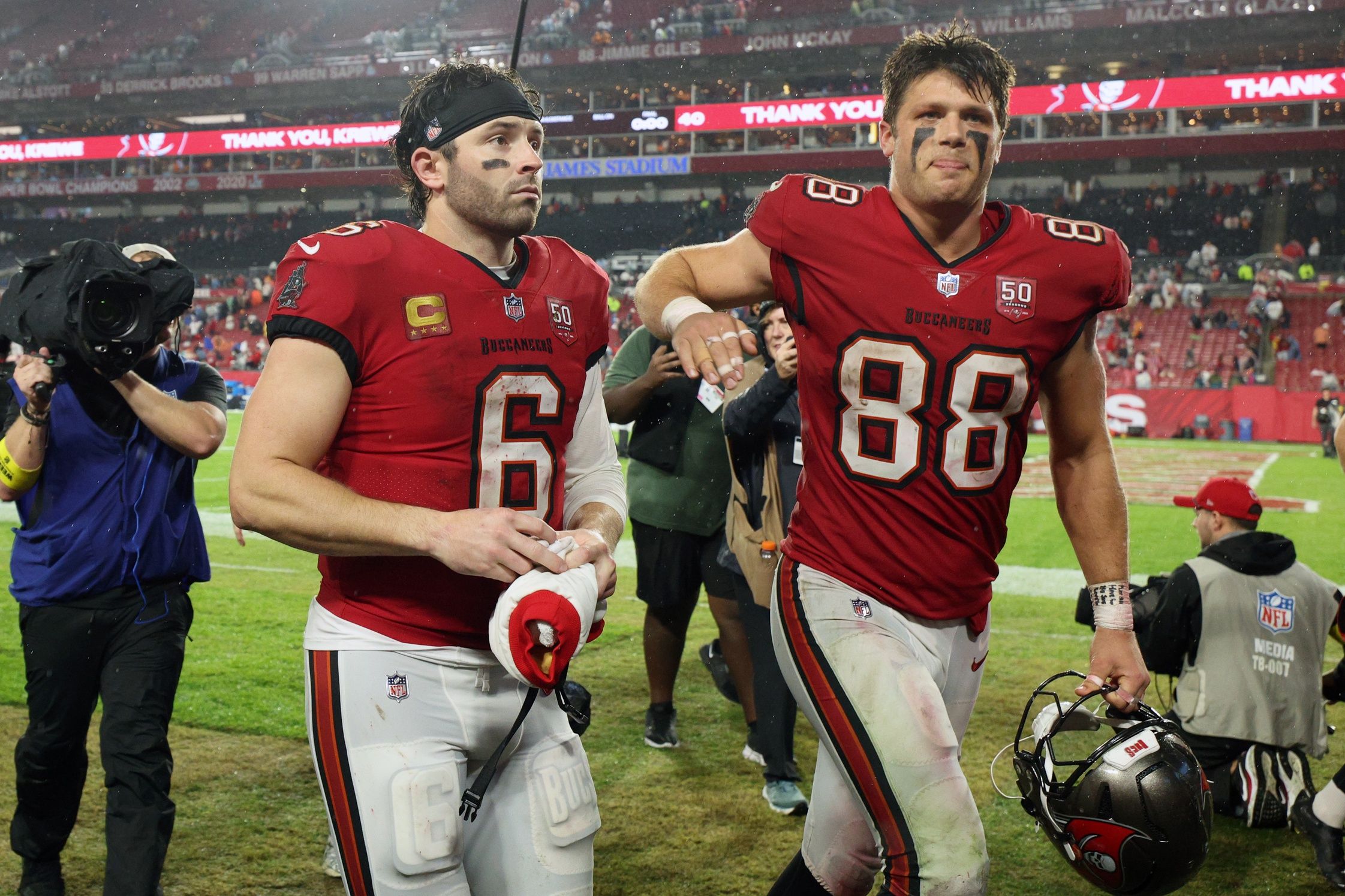 Tampa Bay Buccaneers quarterback Baker Mayfield (6) and tight end Cade Otton (88) leave the field after defeating the Carolina Panthers at Raymond James Stadium.