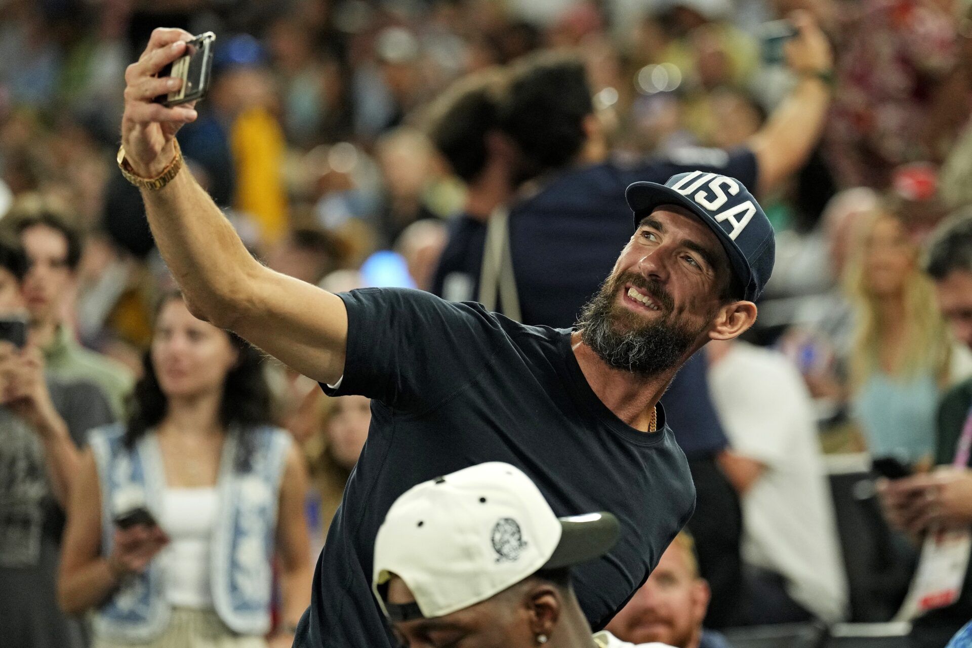 Michael Phelps takes a selfie during the game between the United States and Nigeria in the women’s basketball quarterfinals during the Paris 2024 Olympic Summer Games at Accor Arena.