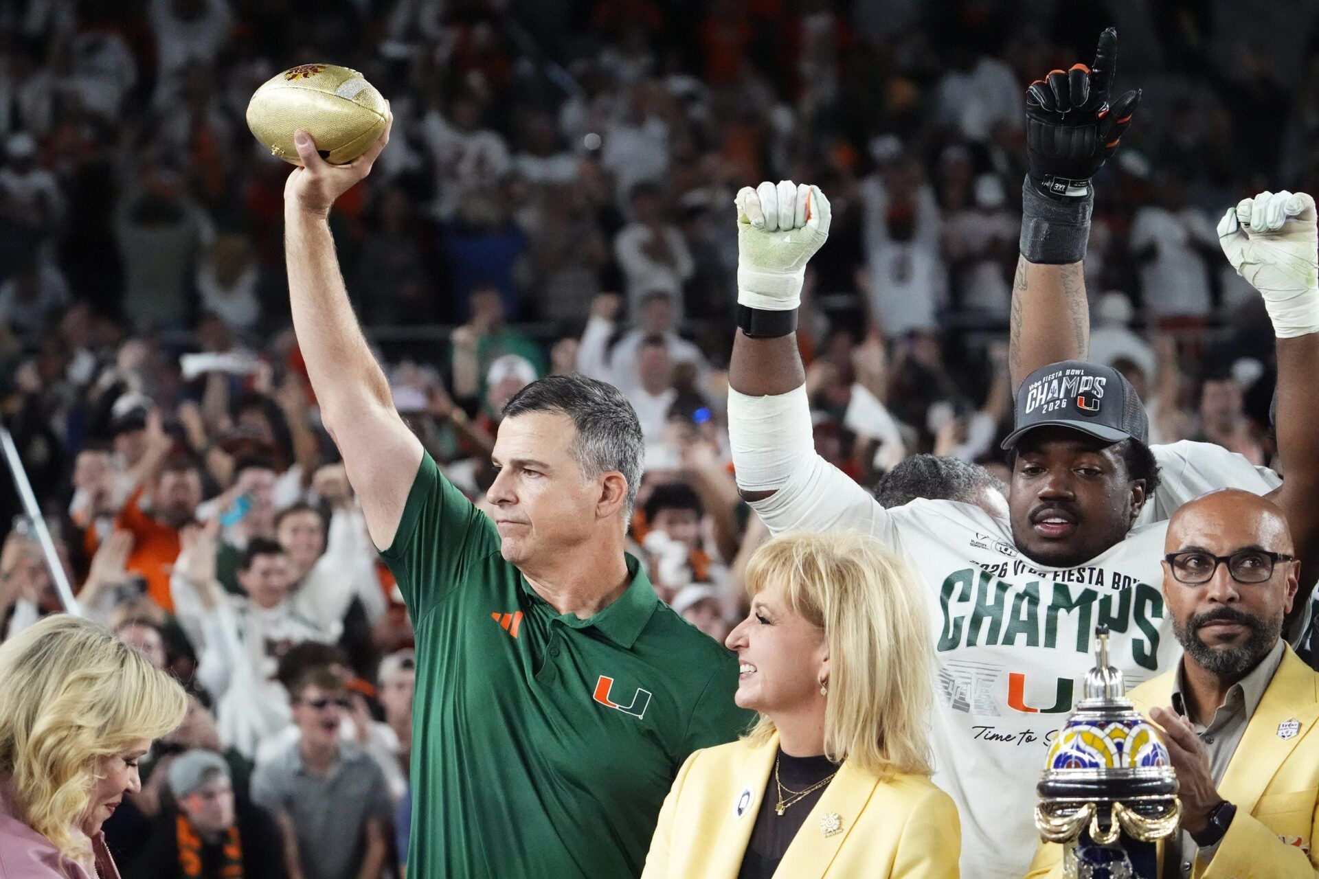 Miami Hurricanes head coach Mario Cristobal lifts the trophy after defeating Ole Miss 31-27 in the Vrbo Fiesta Bowl and CFP semifinal game at State Farm Stadium on Jan. 8, 2026, in Glendale.