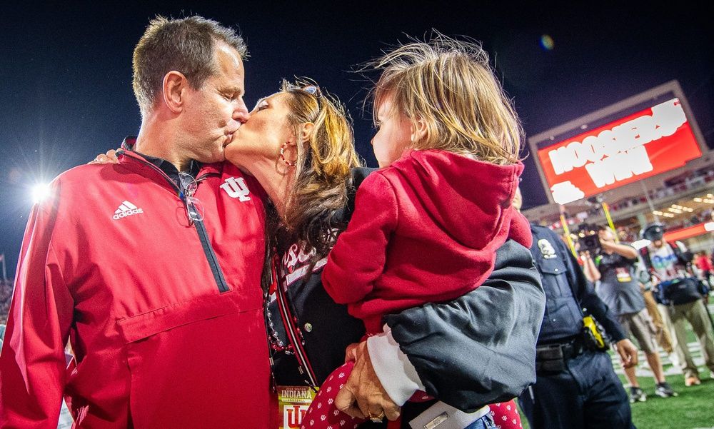 Indiana Head Coach Curt Cignetti kisses his wife Manette Lawer after the Indiana versus Michigan football game at Memorial Stadium on Friday, Nov. 9, 2024.
