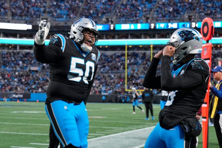 Carolina Panthers quarterback Bryce Young (9) celebrates with guard Robert Hunt (50) after scoring a touchdown in the second quarter at Bank of America Stadium.